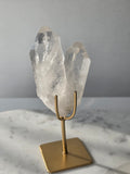 Clear Quartz Lemurian crystal on gold stand featuring exceptional clarity, natural rainbow inclusions, internal formations and striking crystal points