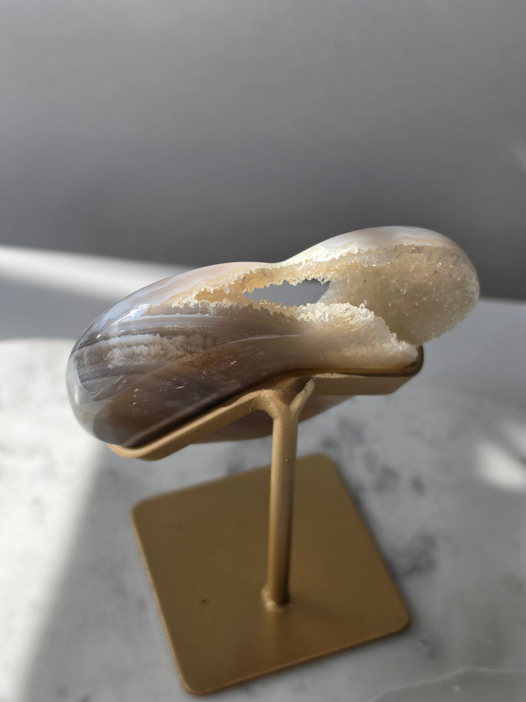 High clarity Druzy Agate Geode Heart on gold stand featuring sparkling druzy crystals, natural agate banding and champagne, taupe and smoky grey tones
