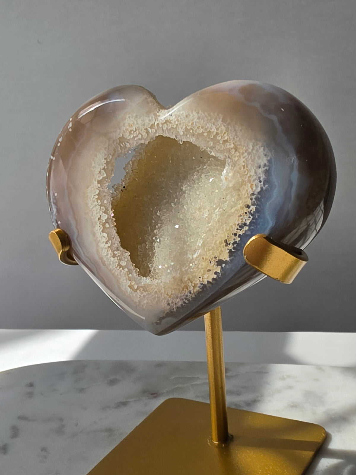 High clarity Druzy Agate Geode Heart on gold stand featuring sparkling druzy crystals, natural agate banding and champagne, taupe and smoky grey tones
