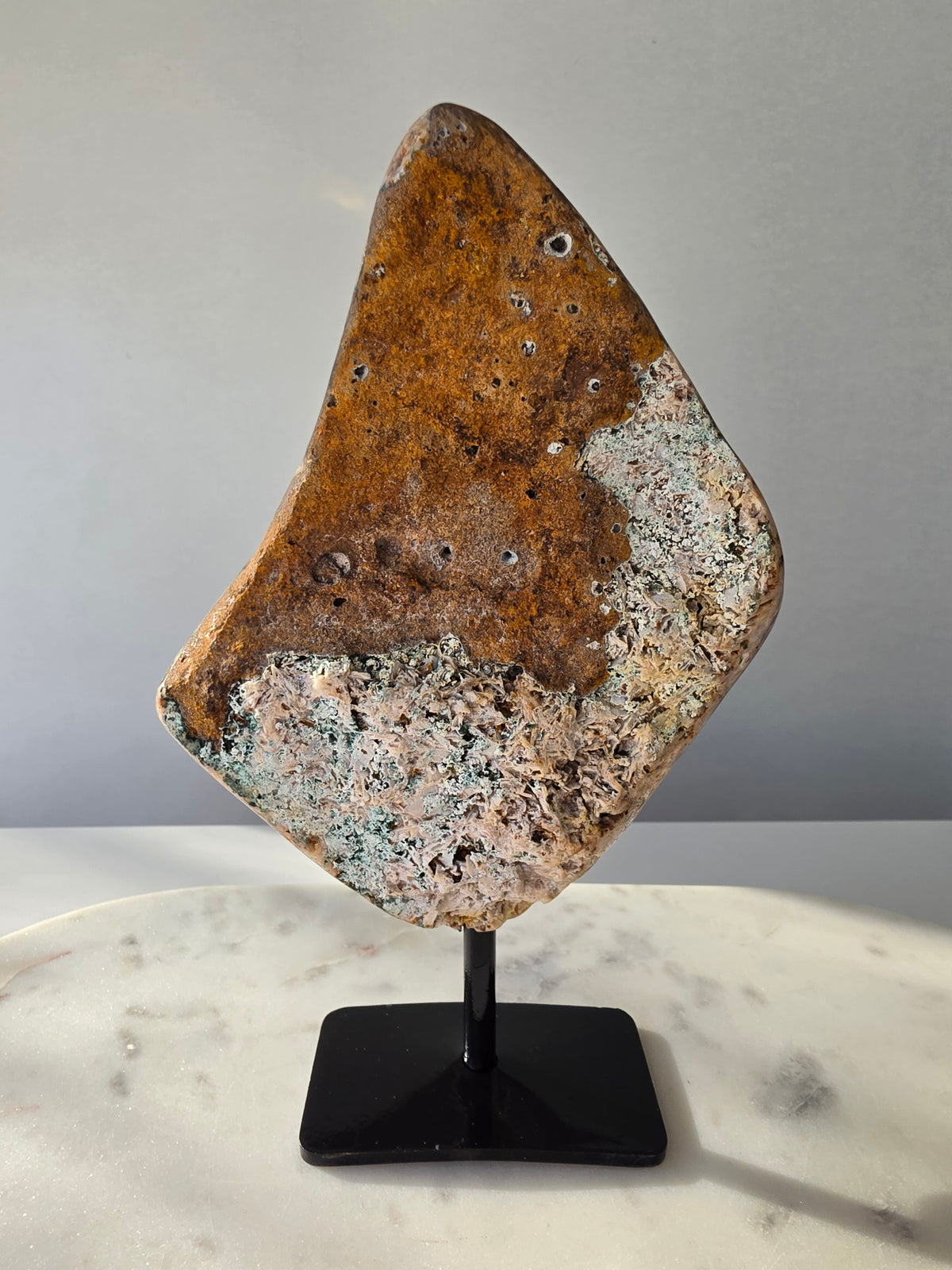 Back view Brazilian Pink Amethyst slab on display stand with rich pink and purple colouring, sparkling purple and pink druzy and natural Jasper inclusions, 645g and 18.5cm