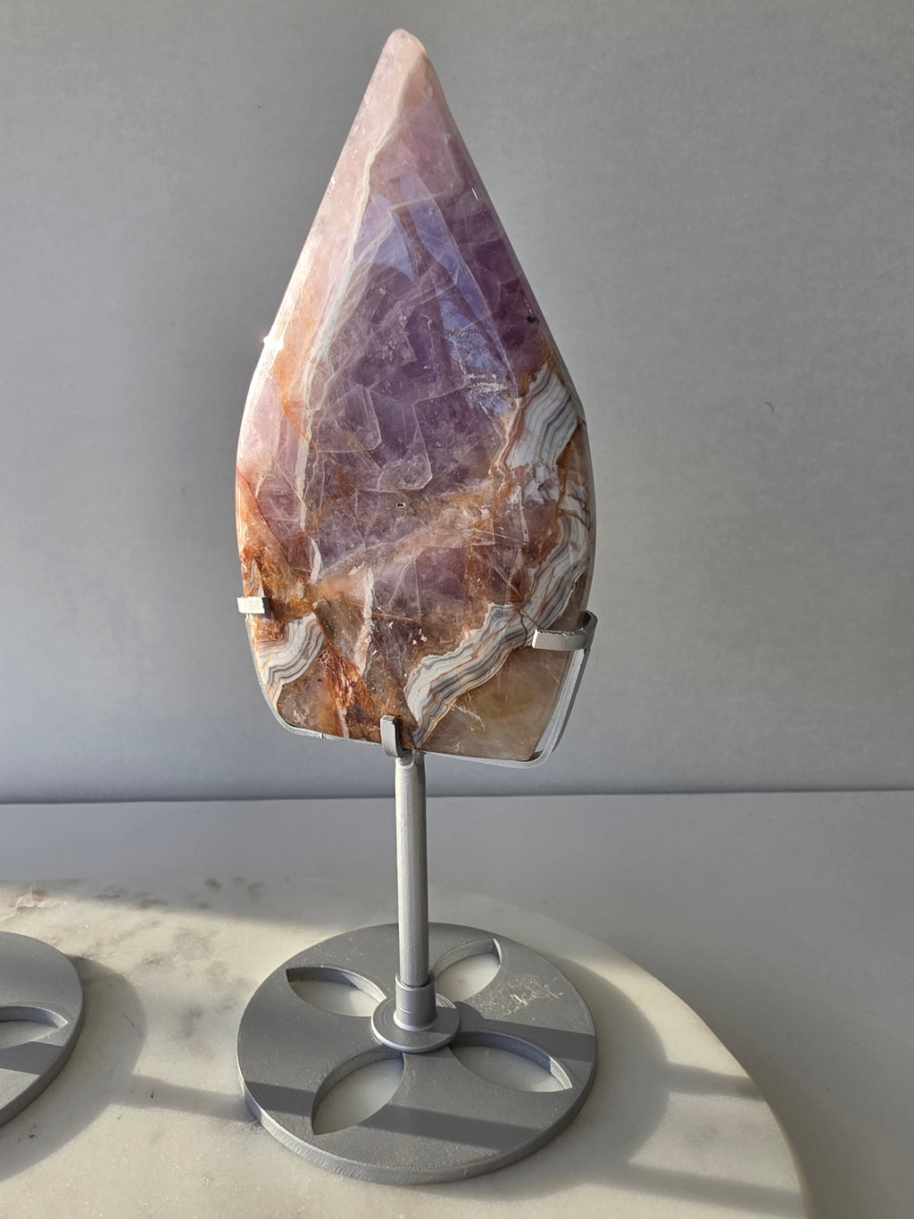 Amethyst Lace Agate flame on a silver stand featuring soft lavender, lilac and creamy white natural banding and intricate lace-like patterns, luxury crystal décor.