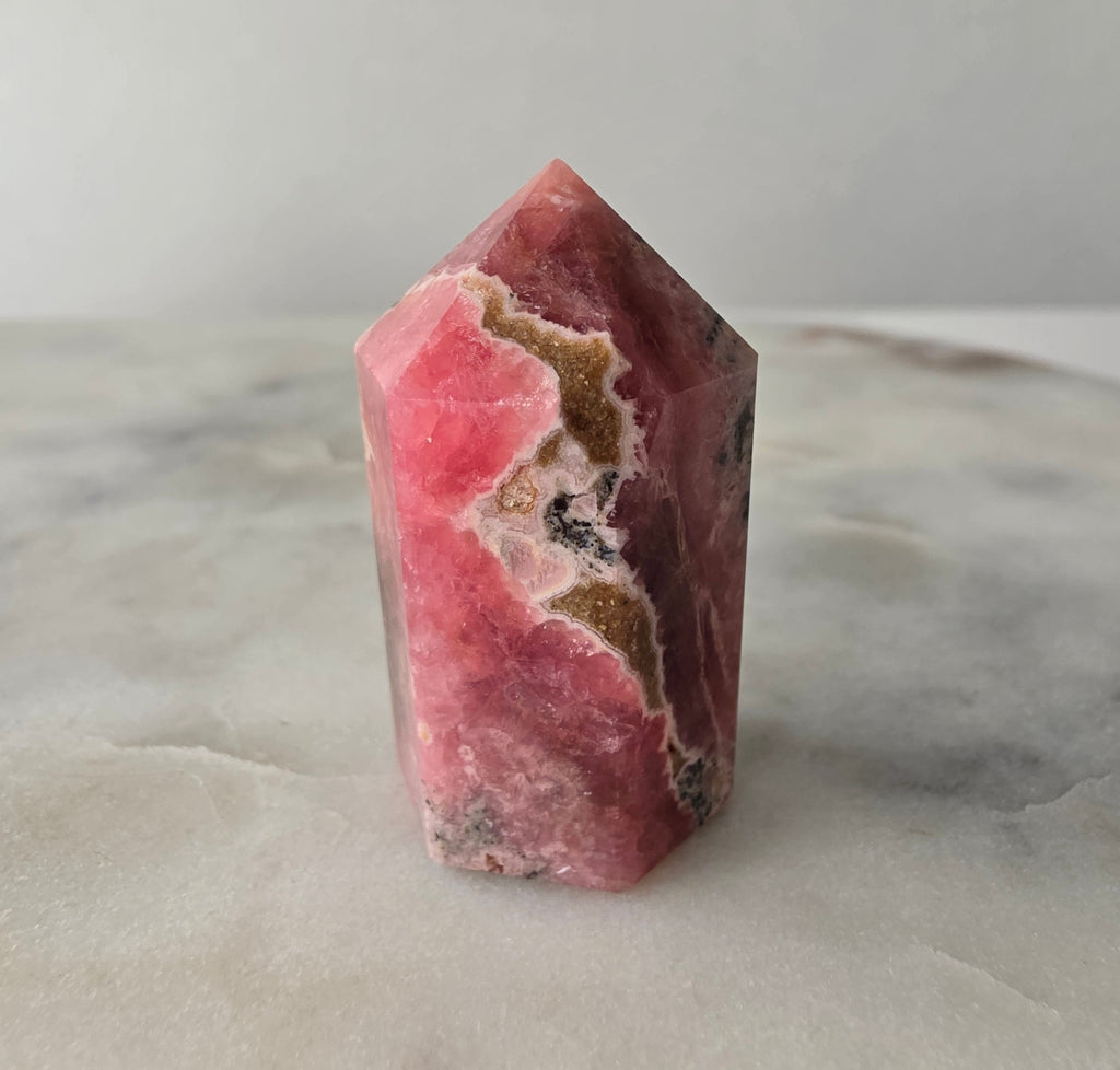 Polished Argentine Rhodochrosite crystal point with deep raspberry pink colour and intricate cream, blush and dark mineral banding, 37g, 4cm.