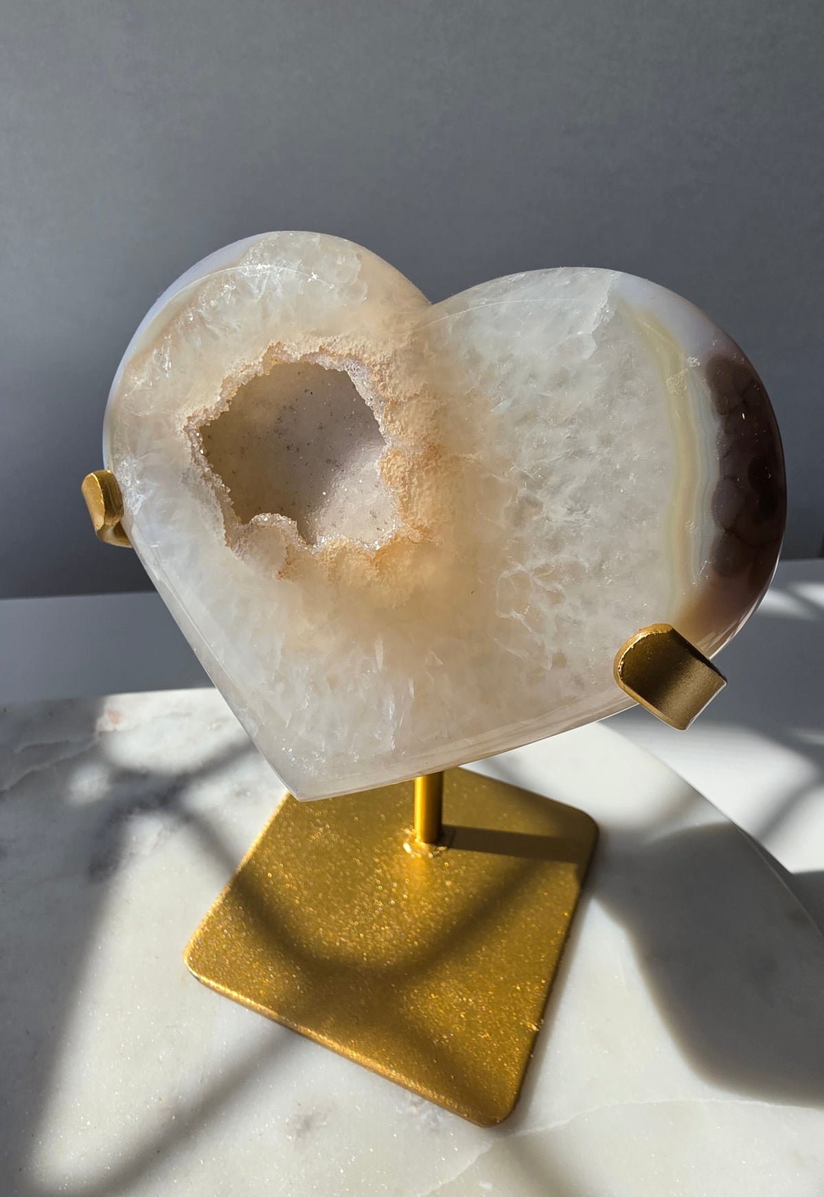 High Clarity Druzy Agate Geode Heart on a gold stand featuring sparkling druzy quartz crystals and natural champagne, caramel, ivory, taupe and smoky-grey agate banding.
