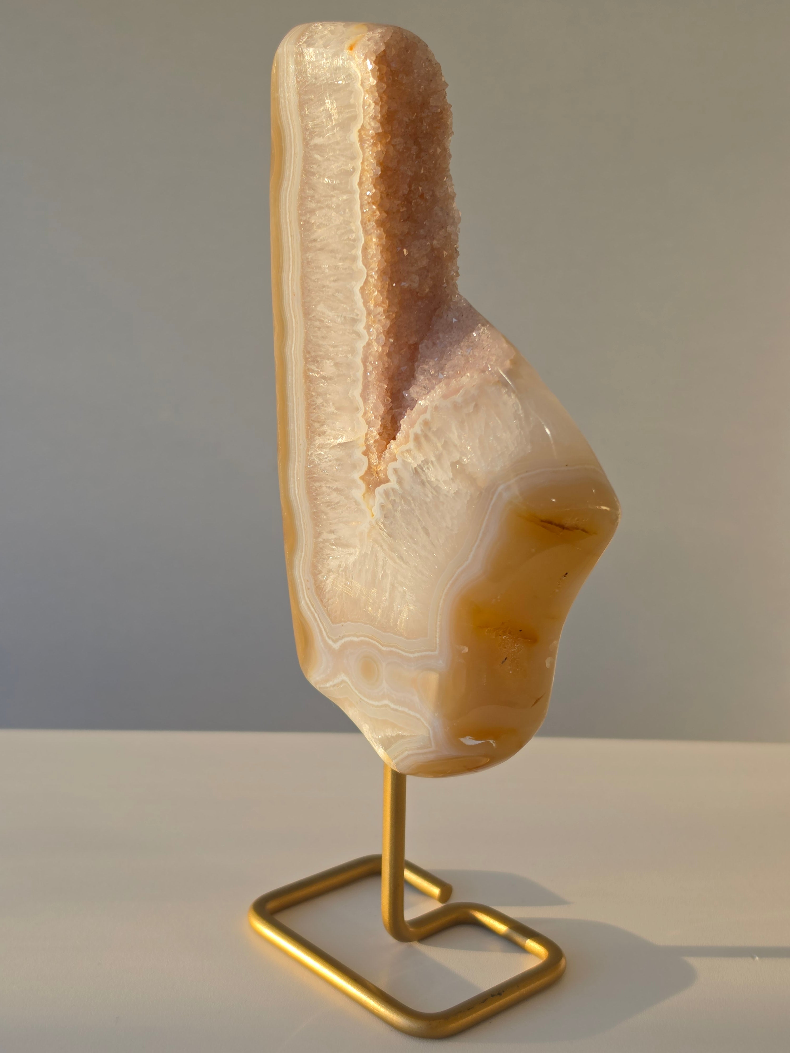 Natural Druzy Agate slab on a brushed gold stand featuring cream, champagne and caramel banding with a sparkling druzy quartz centre, luxury crystal home décor by Stone & Bloom.