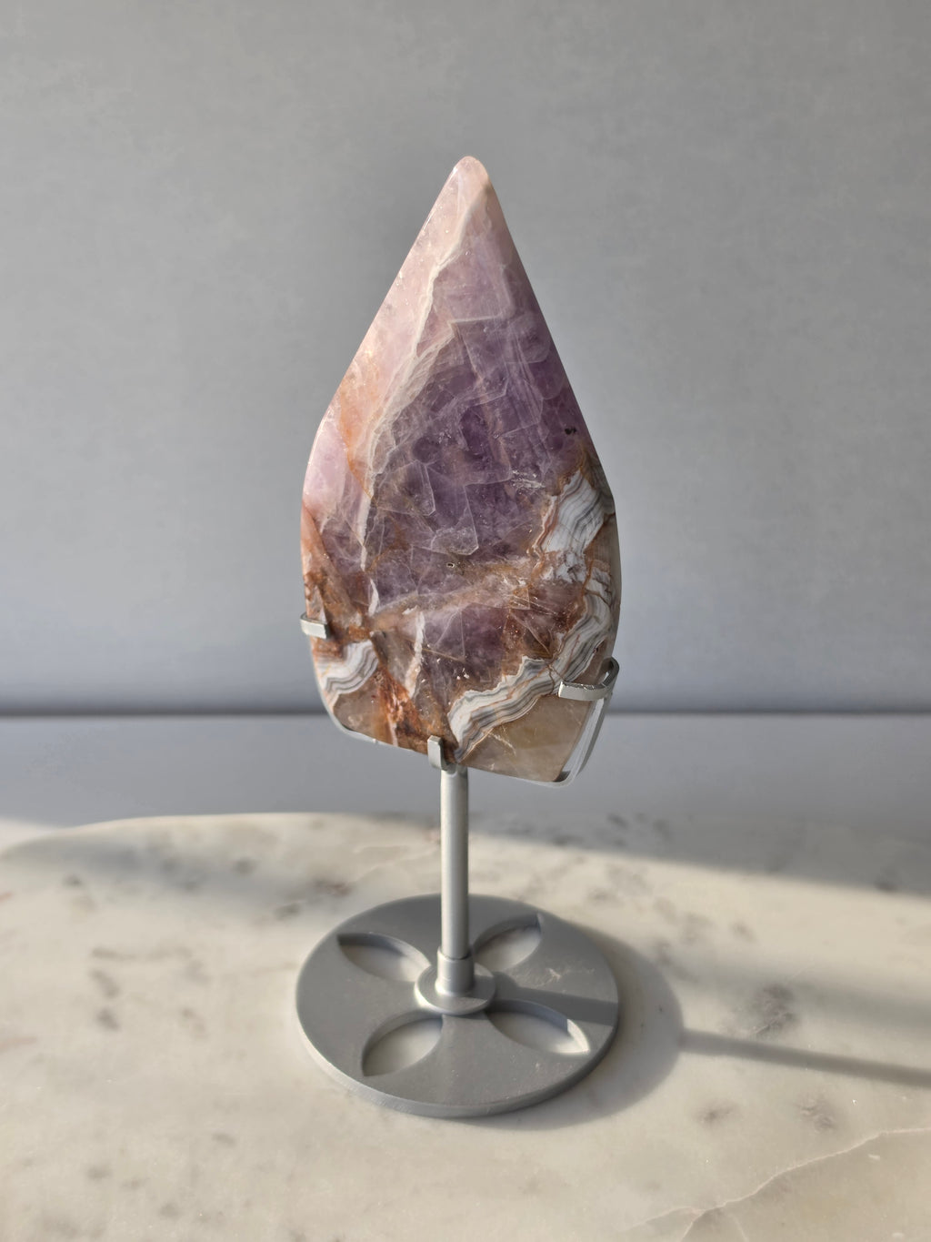 Amethyst Lace Agate flame on a silver stand featuring soft lavender, lilac and creamy white natural banding and intricate lace-like patterns, luxury crystal décor.
