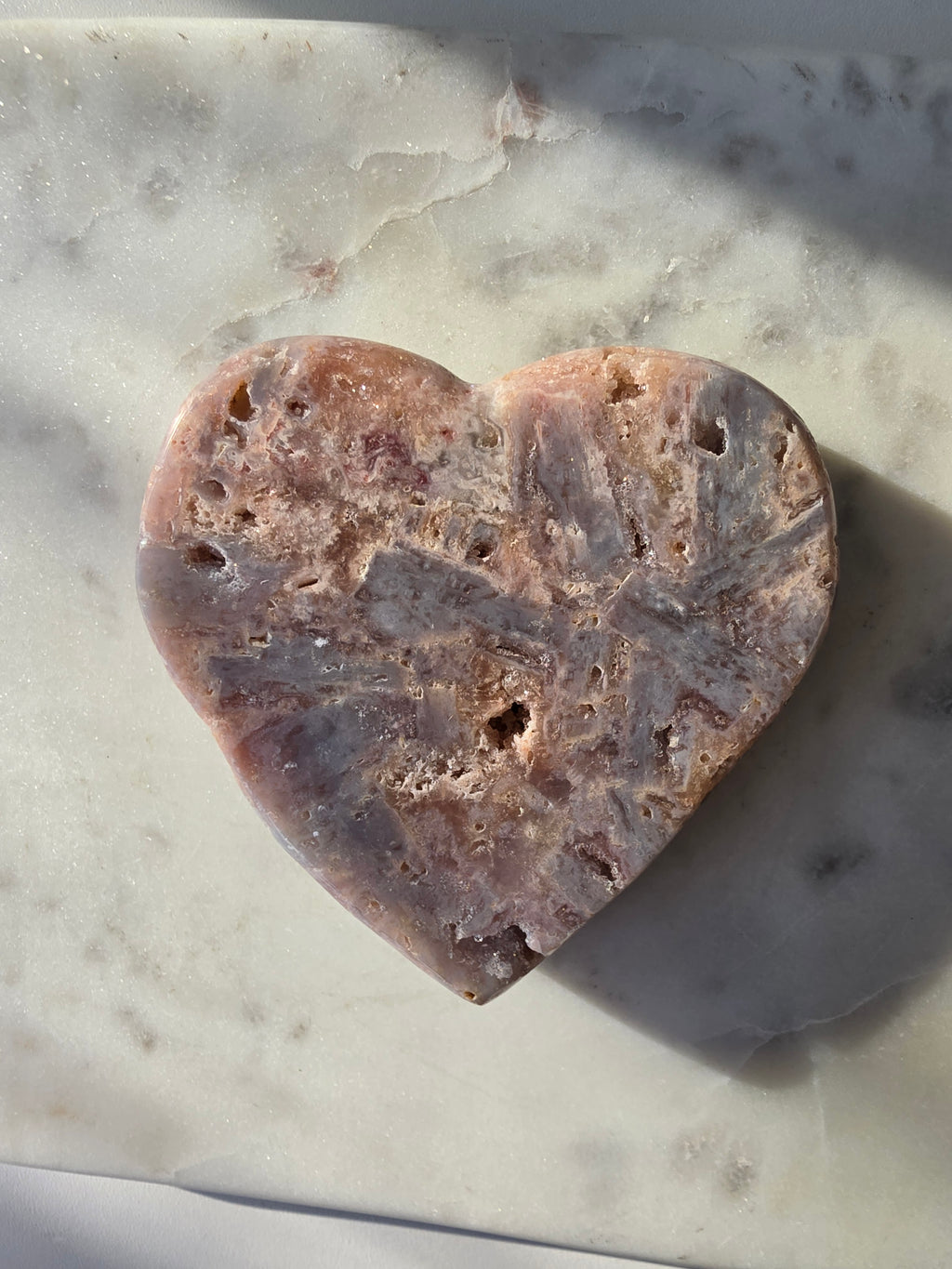 Pink Amethyst heart with soft pink and lilac colouring, intricate palhetados splinter-like formations, natural cavities and sparkling crystalline pockets on a gold stand