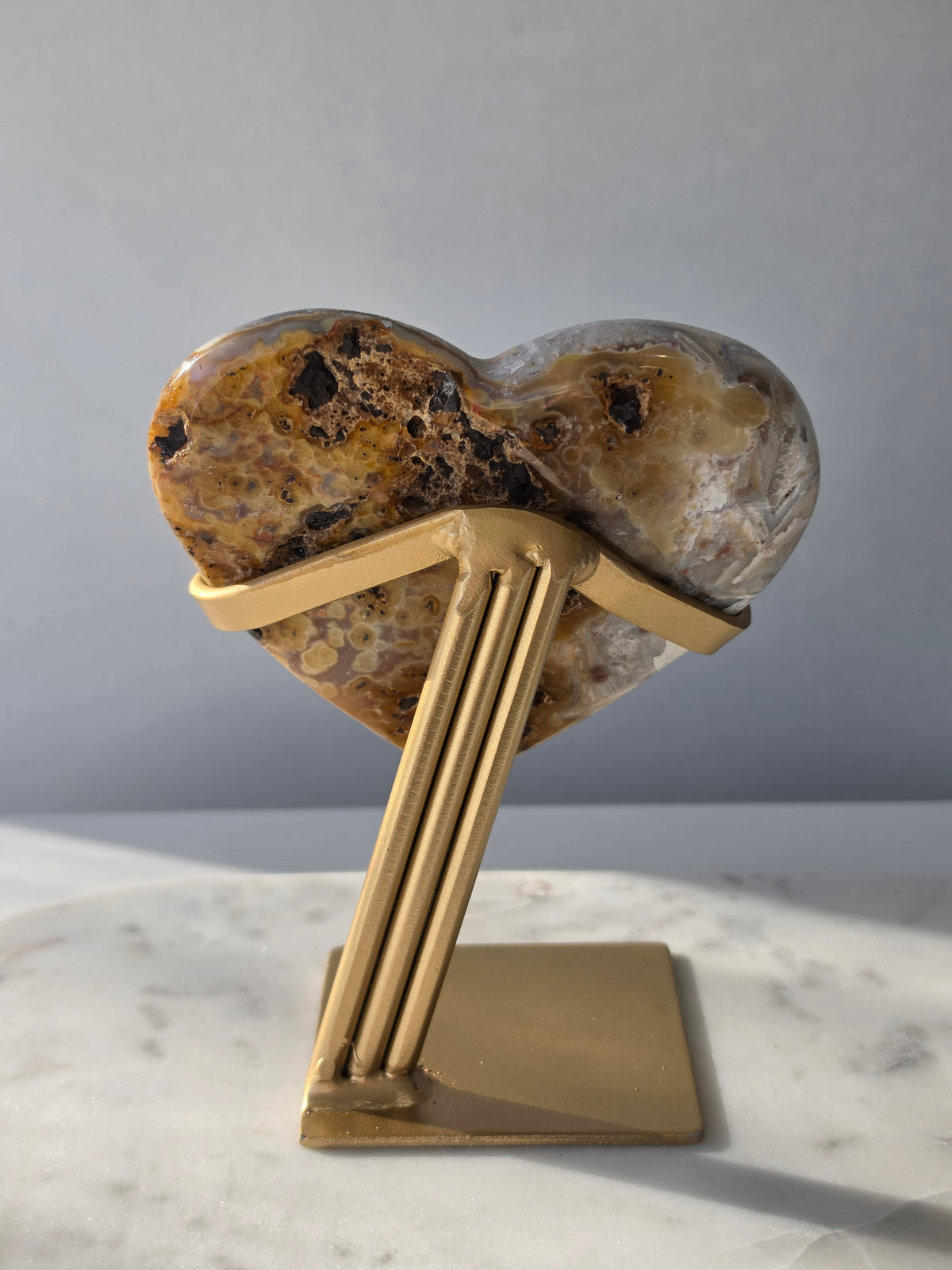 Brazilian Pink Amethyst heart on gold stand featuring intricate white palhetados splinter-like formations, soft blush pink colouring and natural mineral inclusions