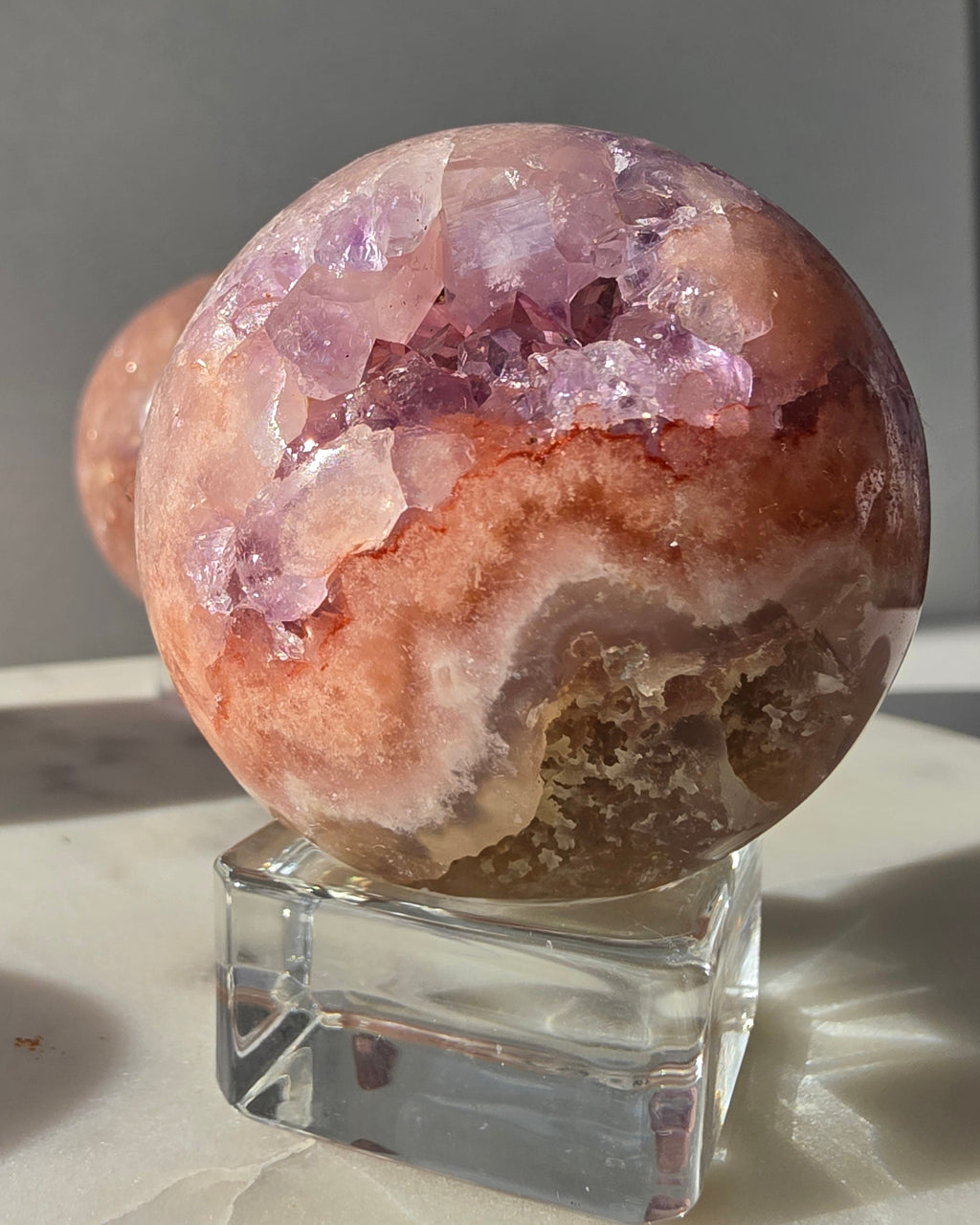 Luxury Pink Amethyst crystal sphere from Brazil with soft blush and lilac tones and a dramatic sparkling crystalline interior