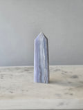 Natural Blue Lace Agate crystal point with soft blue and white banding, polished finish and unique natural formations