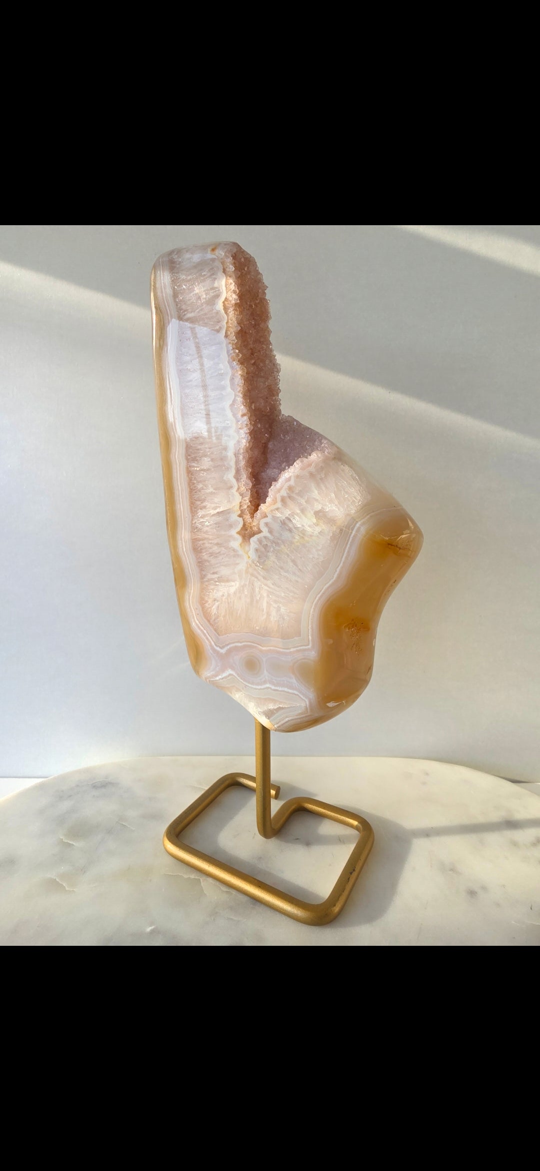 Natural Druzy Agate slab on a brushed gold stand featuring cream, champagne and caramel banding with a sparkling druzy quartz centre, luxury crystal home décor by Stone & Bloom.