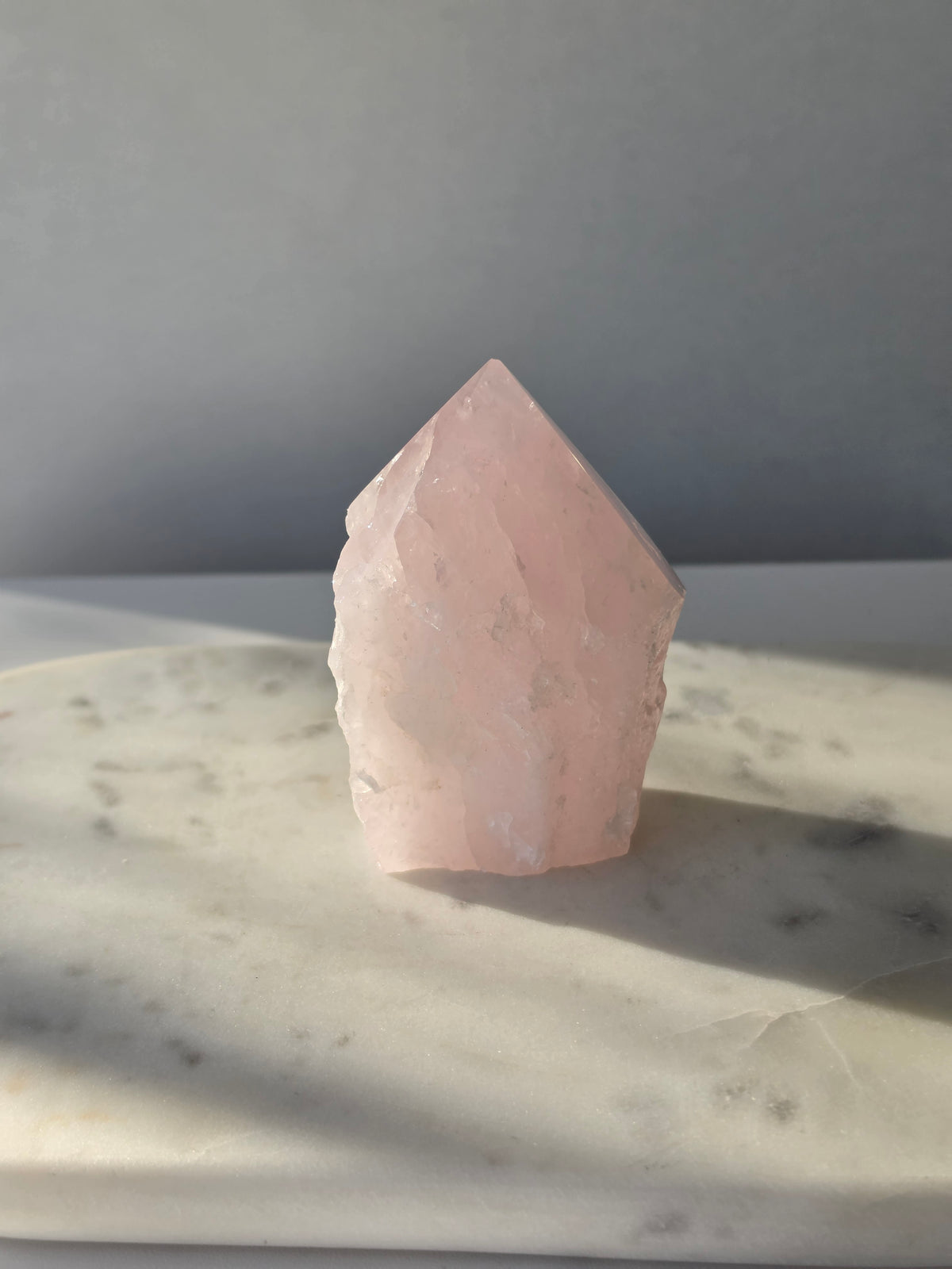 Natural Rose Quartz tower with soft blush-pink colouring, translucent areas and organic crystal formations, weighing 298g and measuring 9.5cm