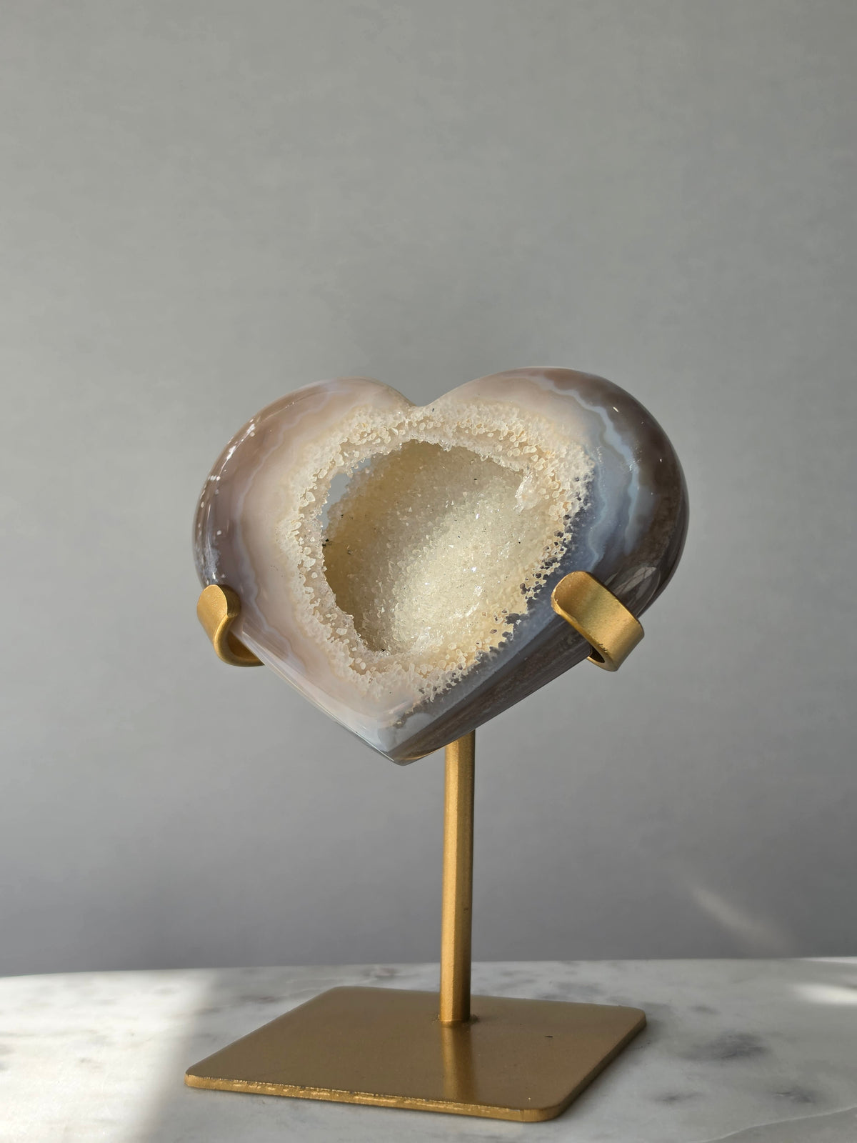 High clarity Druzy Agate Geode Heart on gold stand featuring sparkling druzy crystals, natural agate banding and champagne, taupe and smoky grey tones