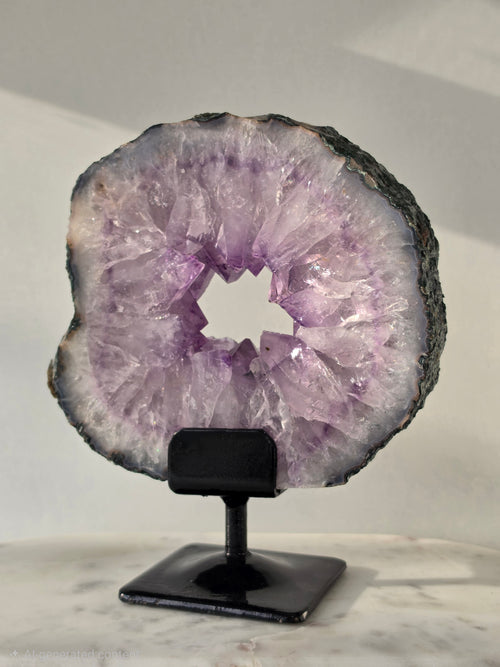 Brazilian Amethyst Portal on stand featuring natural purple quartz crystal druzy, luxury crystal décor, healing crystal display by Stone & Bloom
