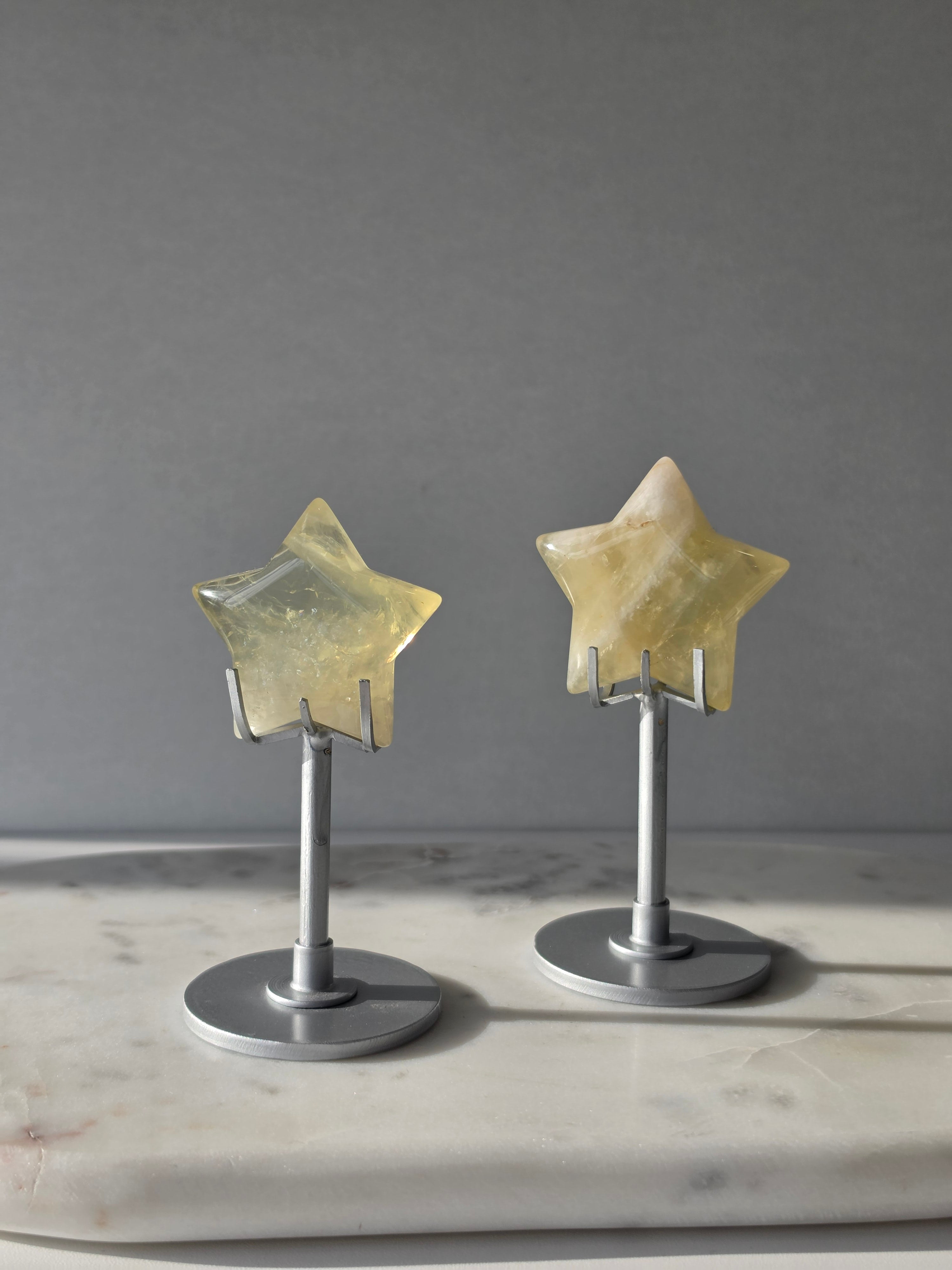 Natural citrine crystal star on a silver stand, featuring translucent golden tones and unique crystal formations, Stone & Bloom statement decor