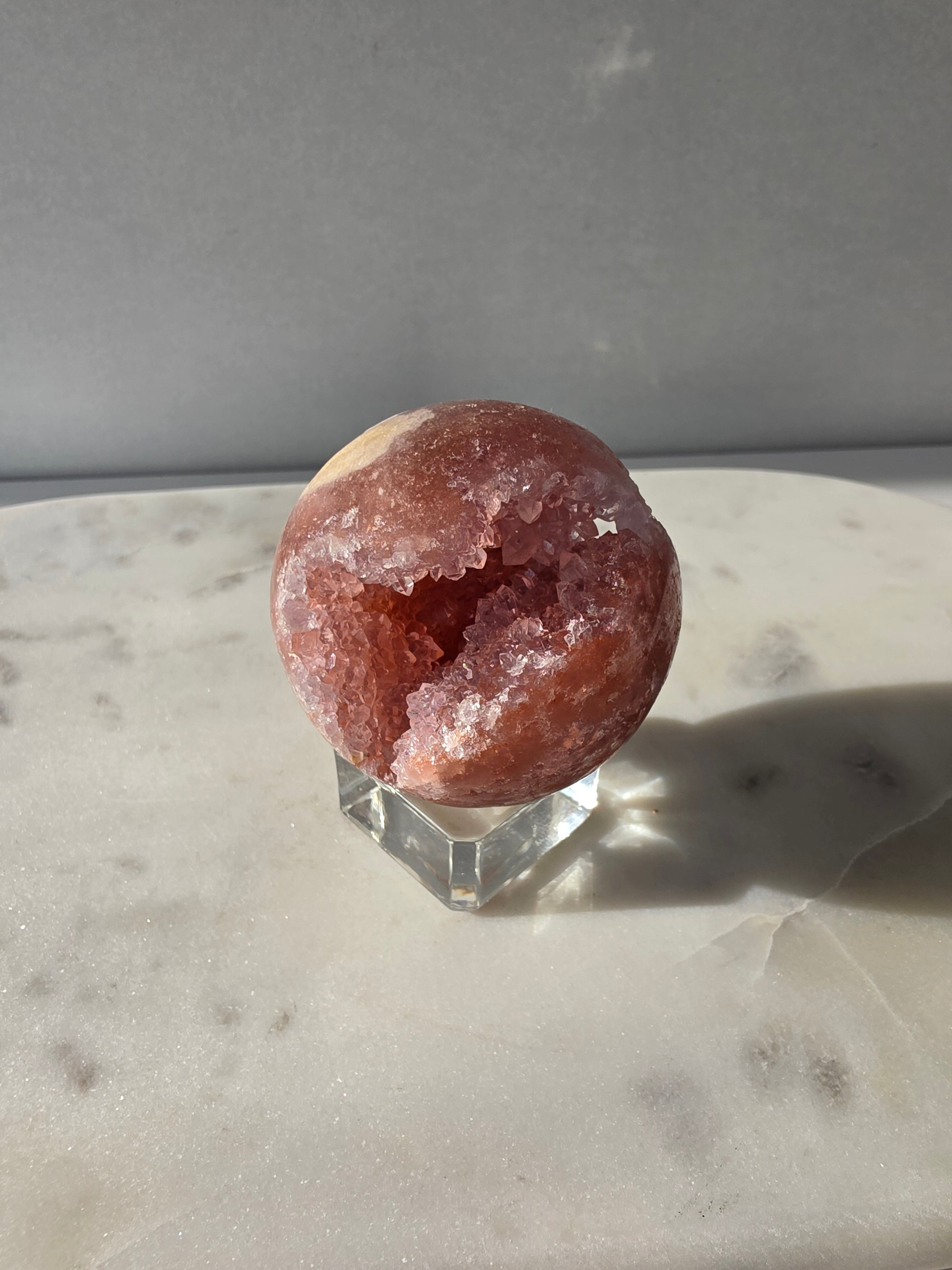 Brazilian Pink Amethyst sphere in rich blush and red-pink tones with sparkling druzy crystal formations and a natural crystalline centre, Stone & Bloom
