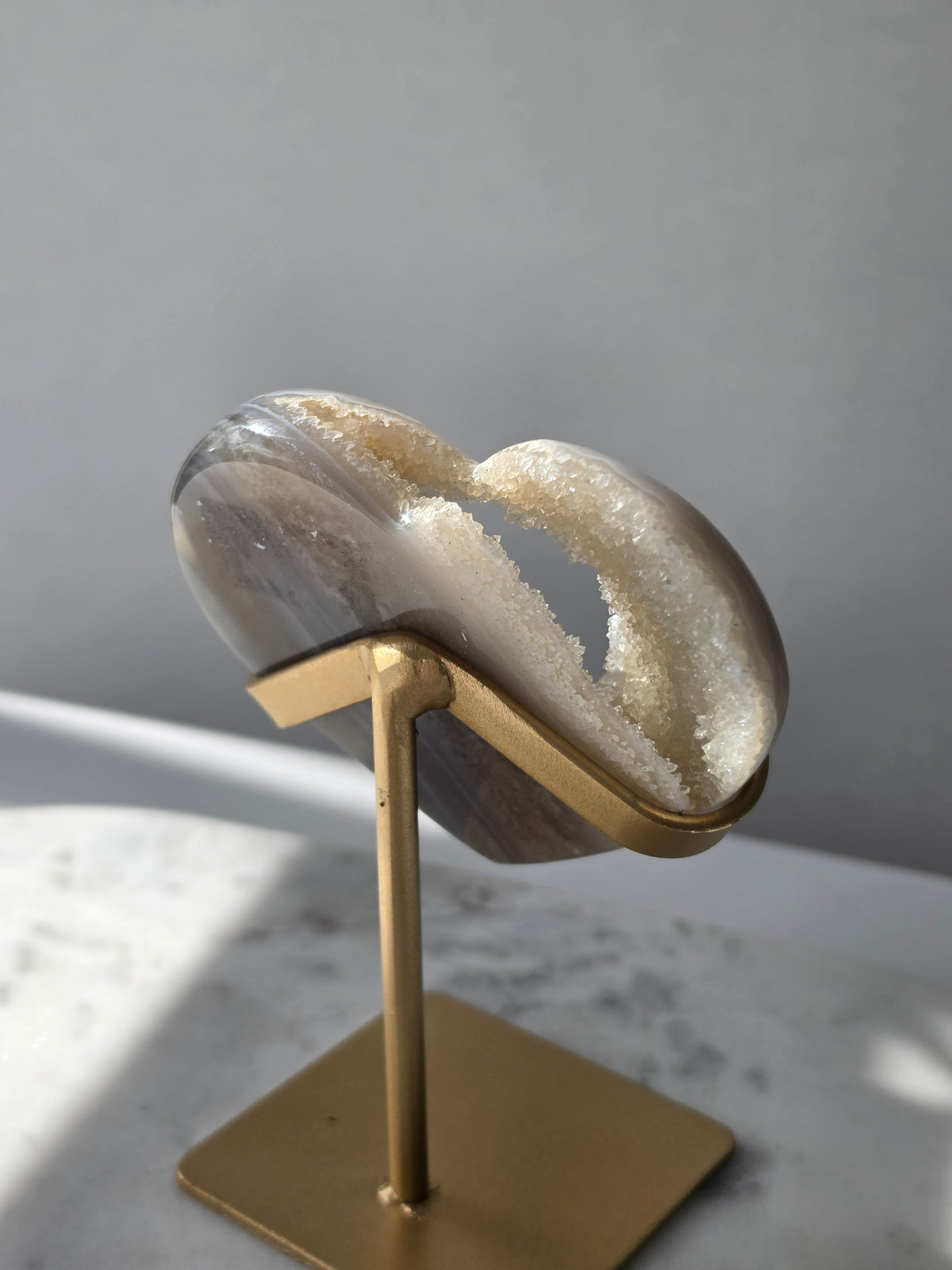High clarity Druzy Agate Geode Heart on gold stand featuring sparkling druzy crystals, natural agate banding and champagne, taupe and smoky grey tones