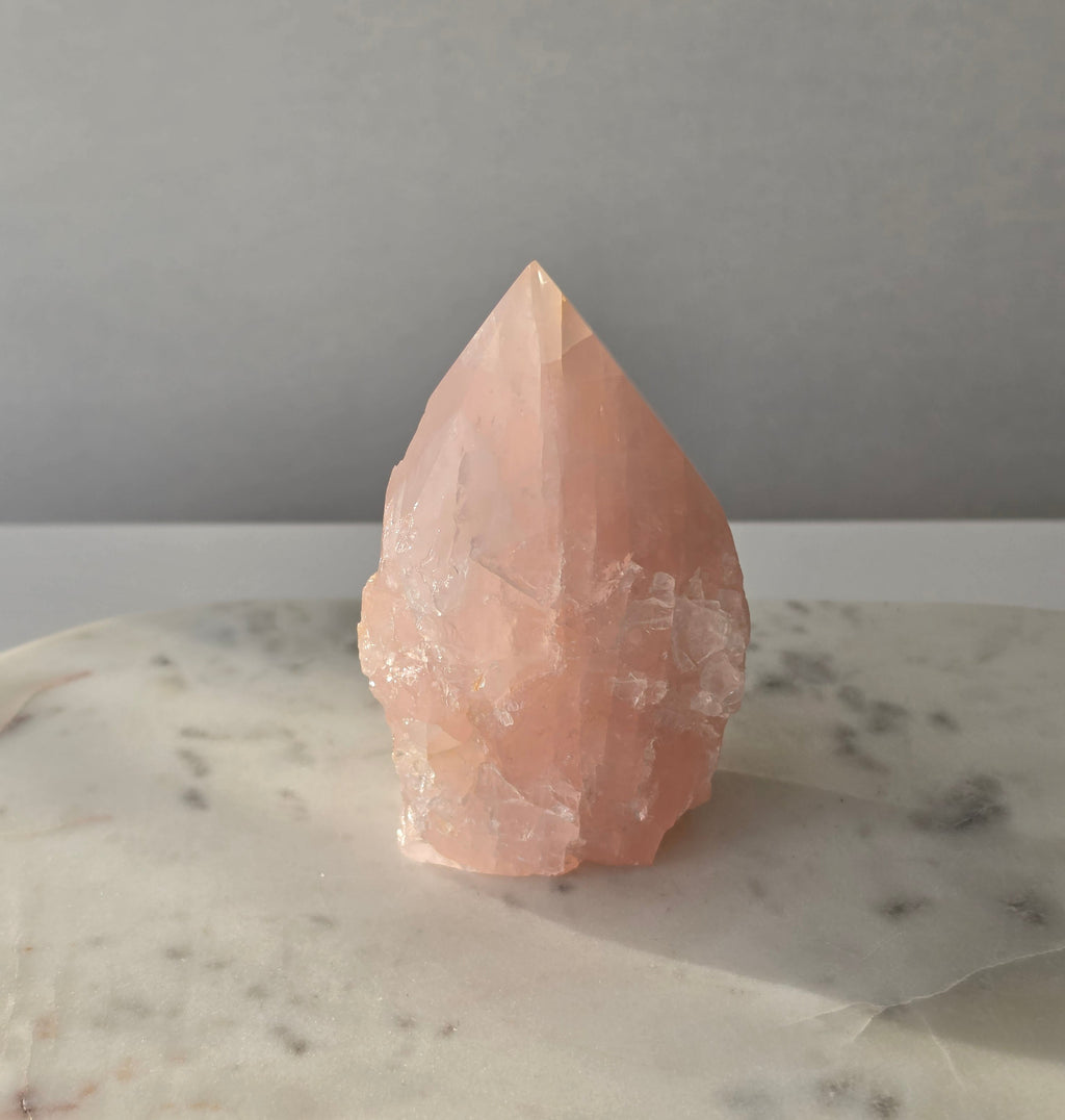 Natural Rose Quartz tower with soft blush-pink colouring and subtle warm golden healer inclusions, weighing 466g and measuring 10cm