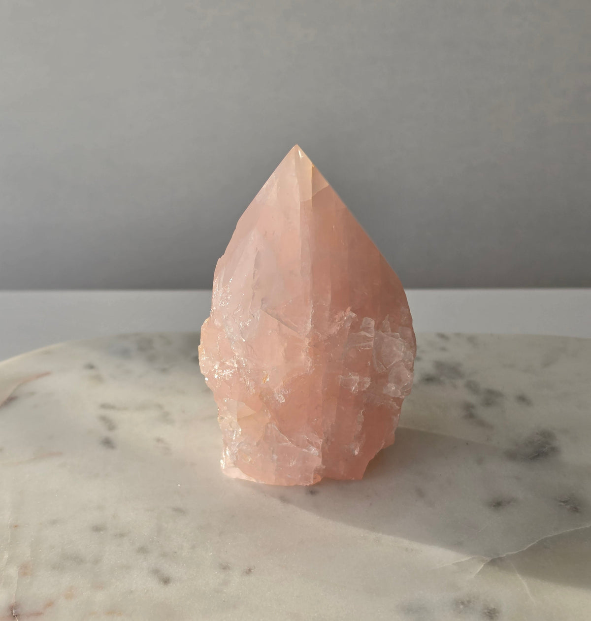 Natural Rose Quartz tower with soft blush-pink colouring and subtle warm golden healer inclusions, weighing 466g and measuring 10cm
