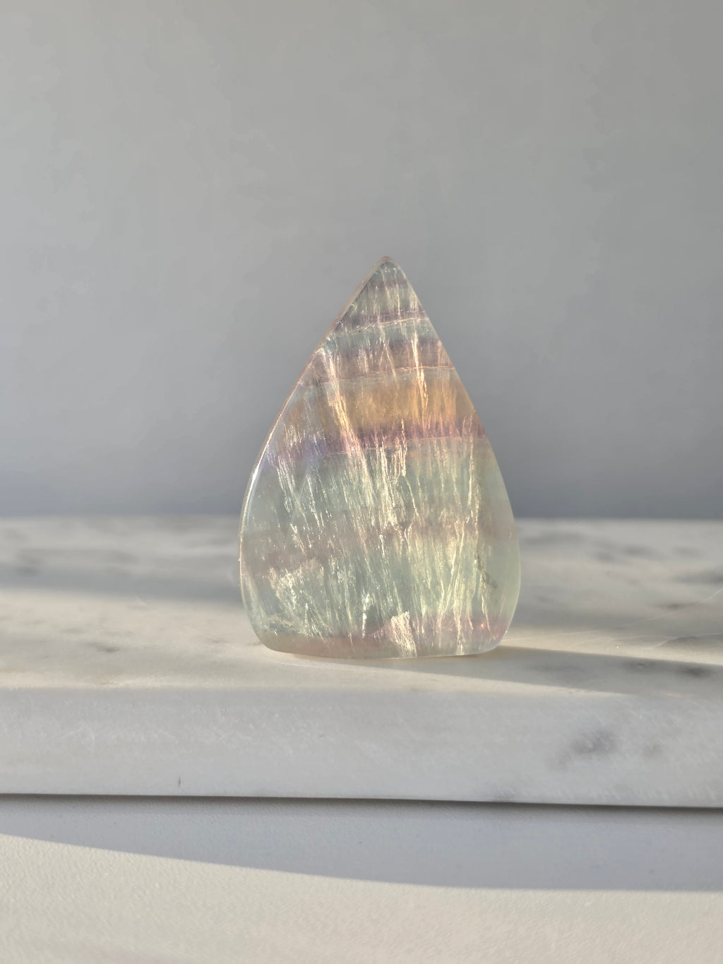 Natural Candy Fluorite crystal flame with pastel purple, blue and green tones, translucent colour zoning and polished finish