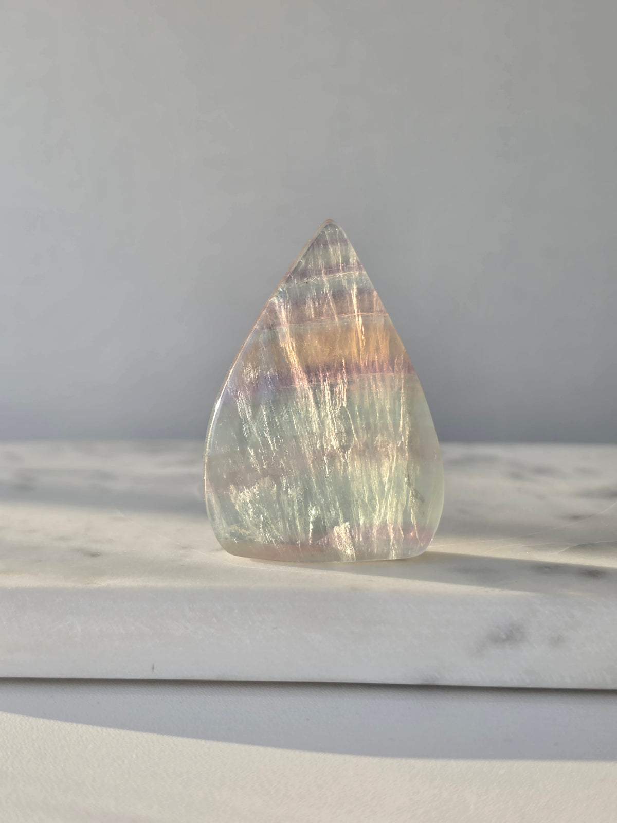 Natural Candy Fluorite crystal flame with pastel purple, blue and green tones, translucent colour zoning and polished finish