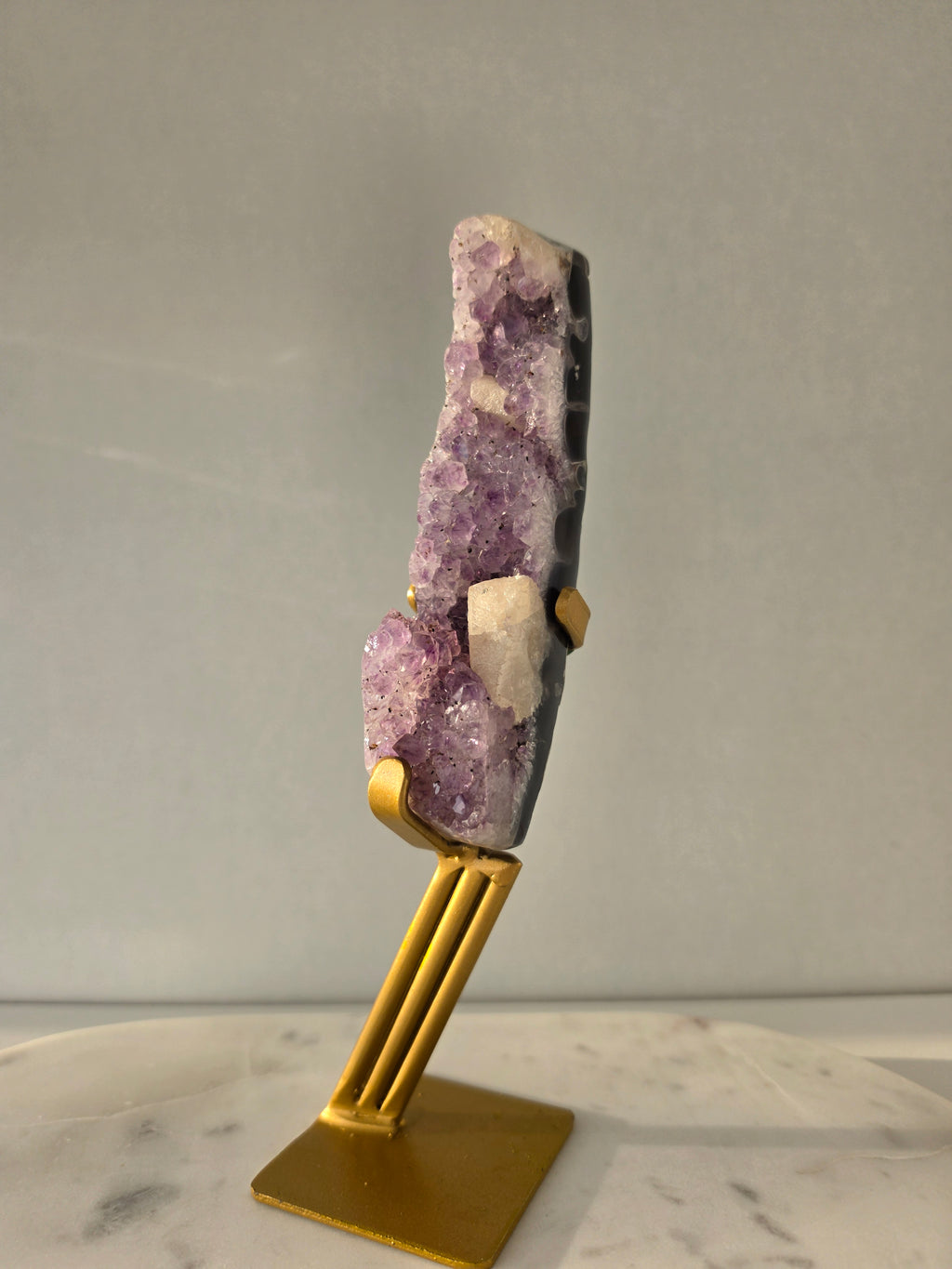 Brazilian Purple Amethyst Freeform with natural golden Calcite on gold stand, featuring sparkling druzy crystal points and polished finish – luxury crystal home décor by Stone & Bloom.