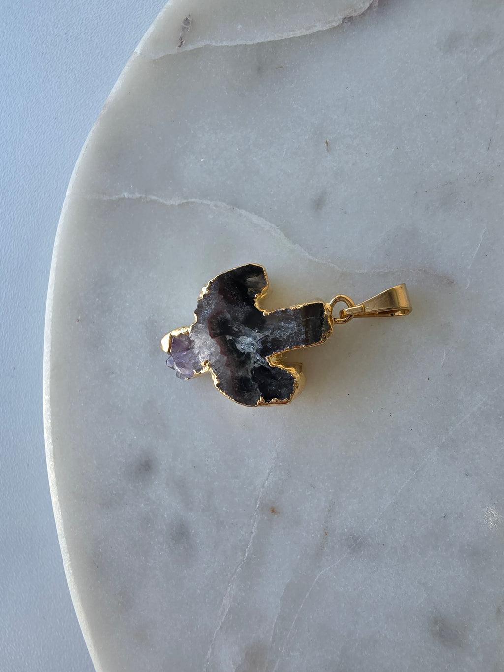 Amethyst and agate cactus slice pendant featuring deep translucent smoky-grey agate, red banding and purple crystal formations and a 24K gold-plated outline.