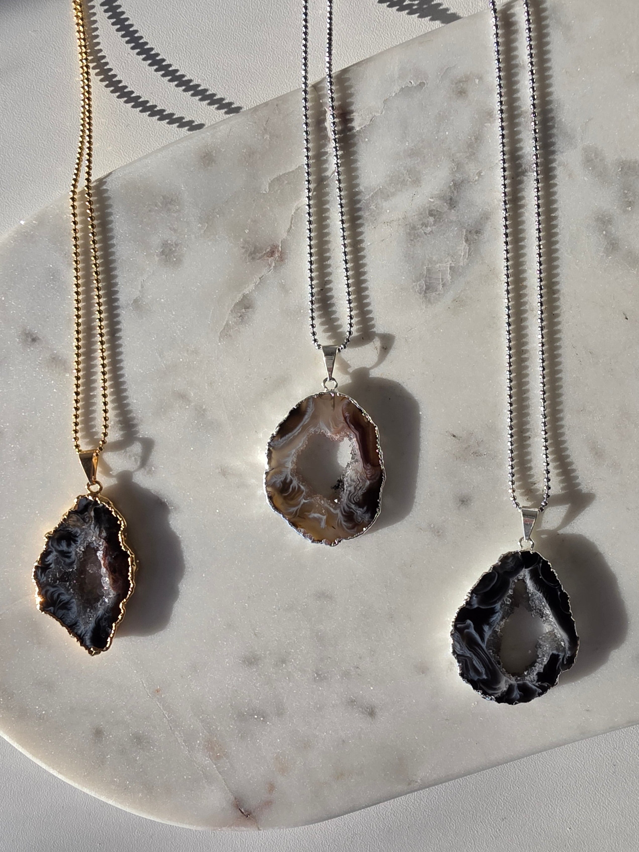 "Brazilian Agate Geode Slice Pendant in natural [brown/black/grey] tones on a silver plated chain with sparkling druzy crystal formations"