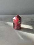Polished Argentine Rhodochrosite crystal point with deep raspberry pink colour and intricate cream, blush and dark mineral banding, 37g, 4cm.
