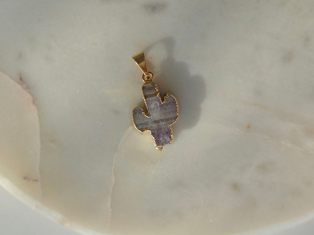 Amethyst and agate cactus slice pendant featuring agate banding, purple crystal formations and a 24K gold-plated outline.