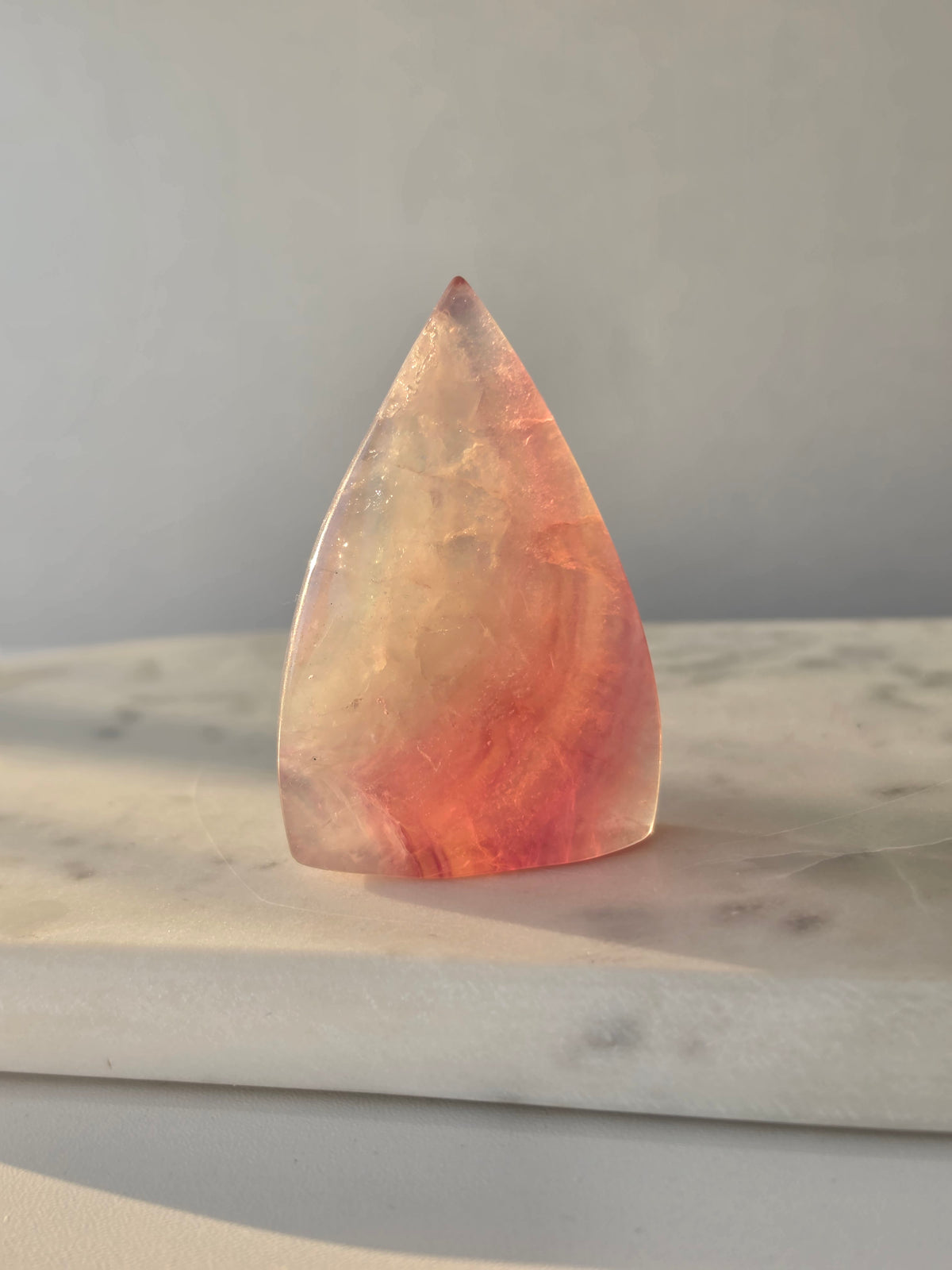 Natural Candy Fluorite crystal flame with pastel purple, blue and green tones, translucent colour zoning and polished finish