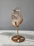 High-grade Nepalese Pink Himalayan Quartz statement piece, 606g and 19cm tall, featuring delicate pink tones, translucent crystal formations and natural inclusions, displayed on a gold stand.