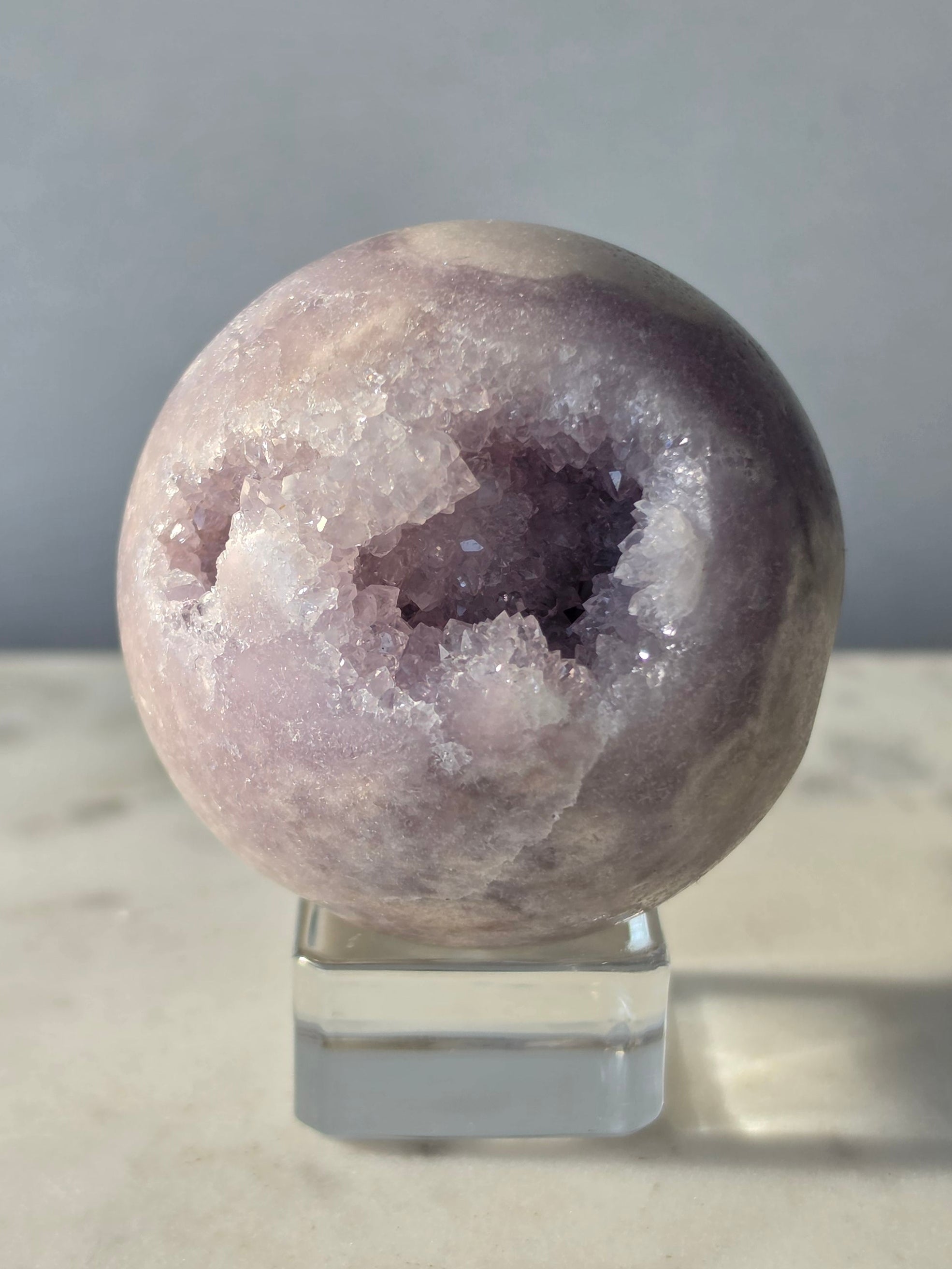 Brazilian Pink Amethyst sphere in soft lilac and lavender tones featuring a sparkling druzy cavity with a natural amethyst flower formation