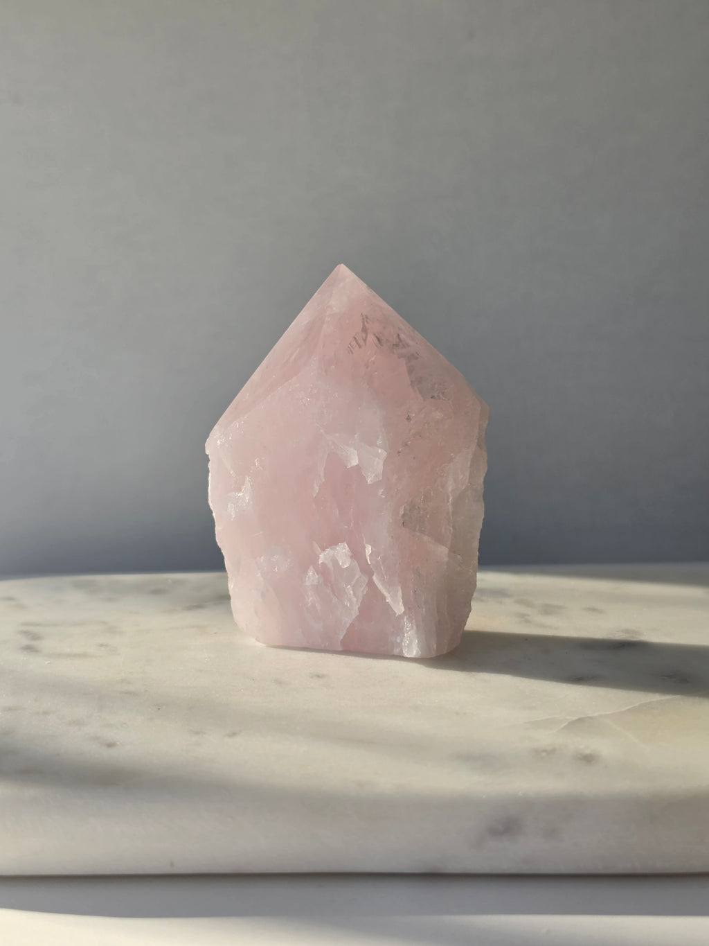 Natural Rose Quartz tower with soft blush-pink colouring, translucent areas and organic crystal formations, weighing 298g and measuring 9.5cm