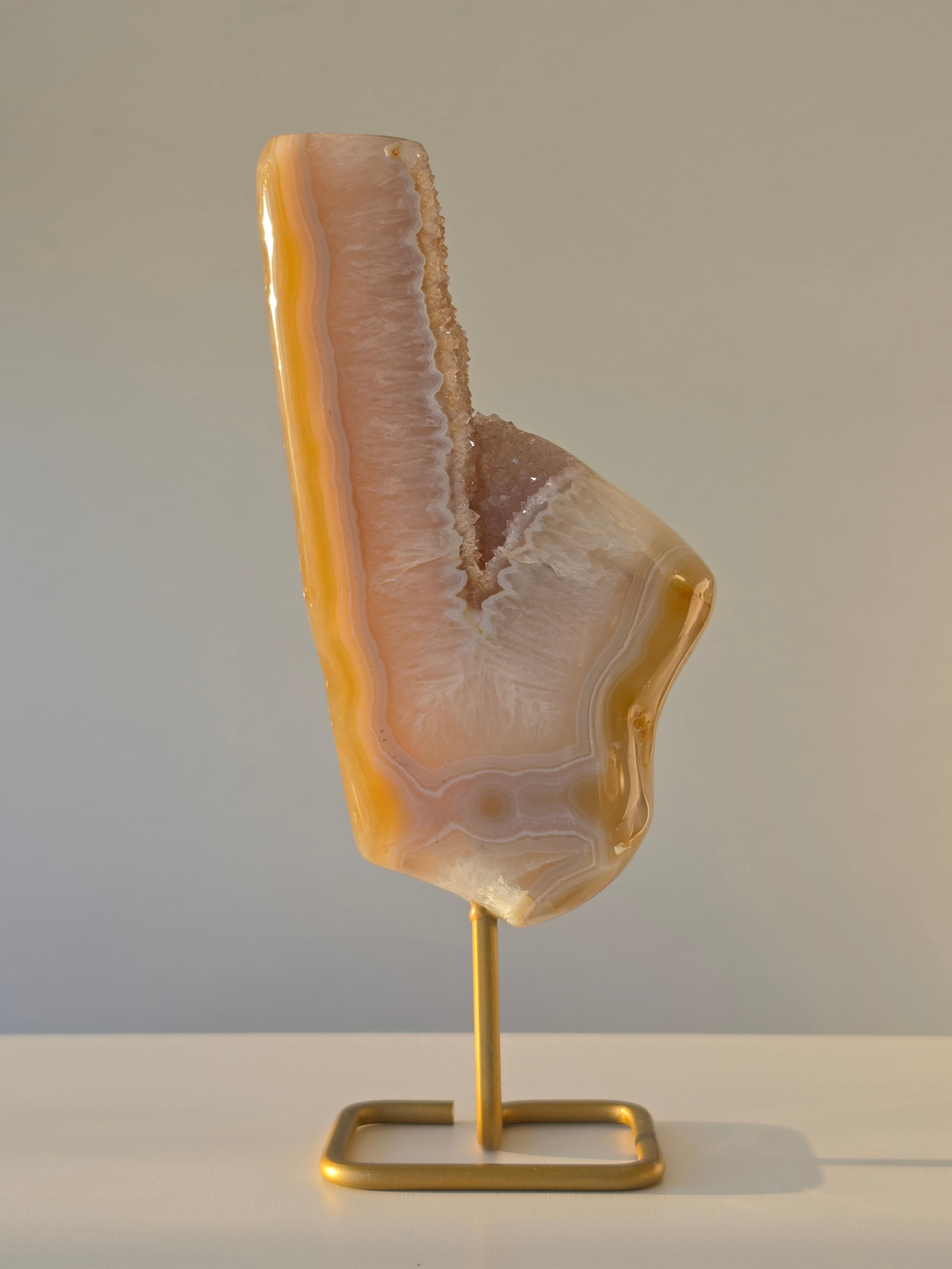 Natural Druzy Agate slab on a brushed gold stand featuring cream, champagne and caramel banding with a sparkling druzy quartz centre, luxury crystal home décor by Stone & Bloom.