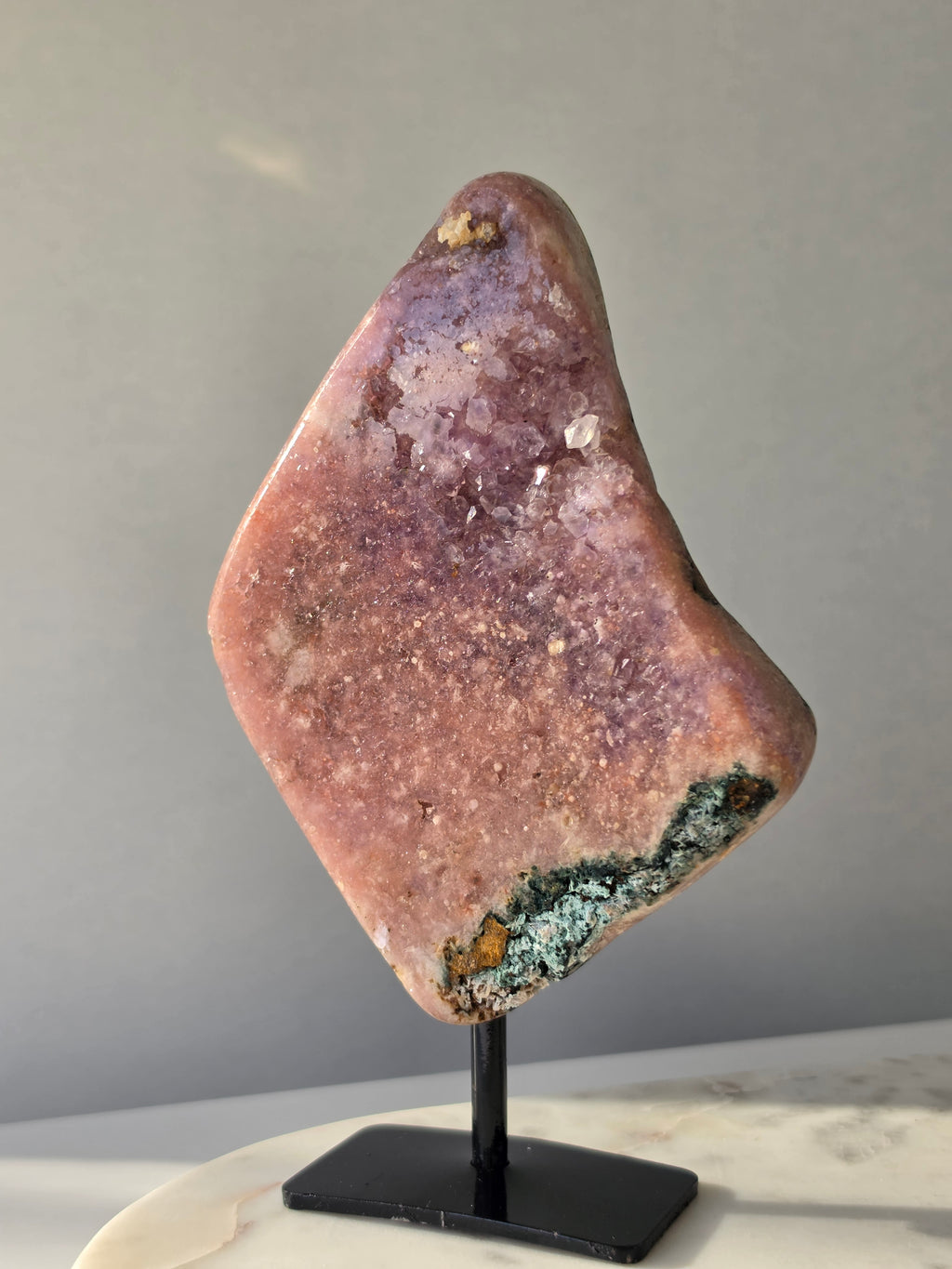 Brazilian Pink Amethyst slab on display stand with rich pink and purple colouring, sparkling purple and pink druzy and natural Jasper inclusions, 645g and 18.5cm