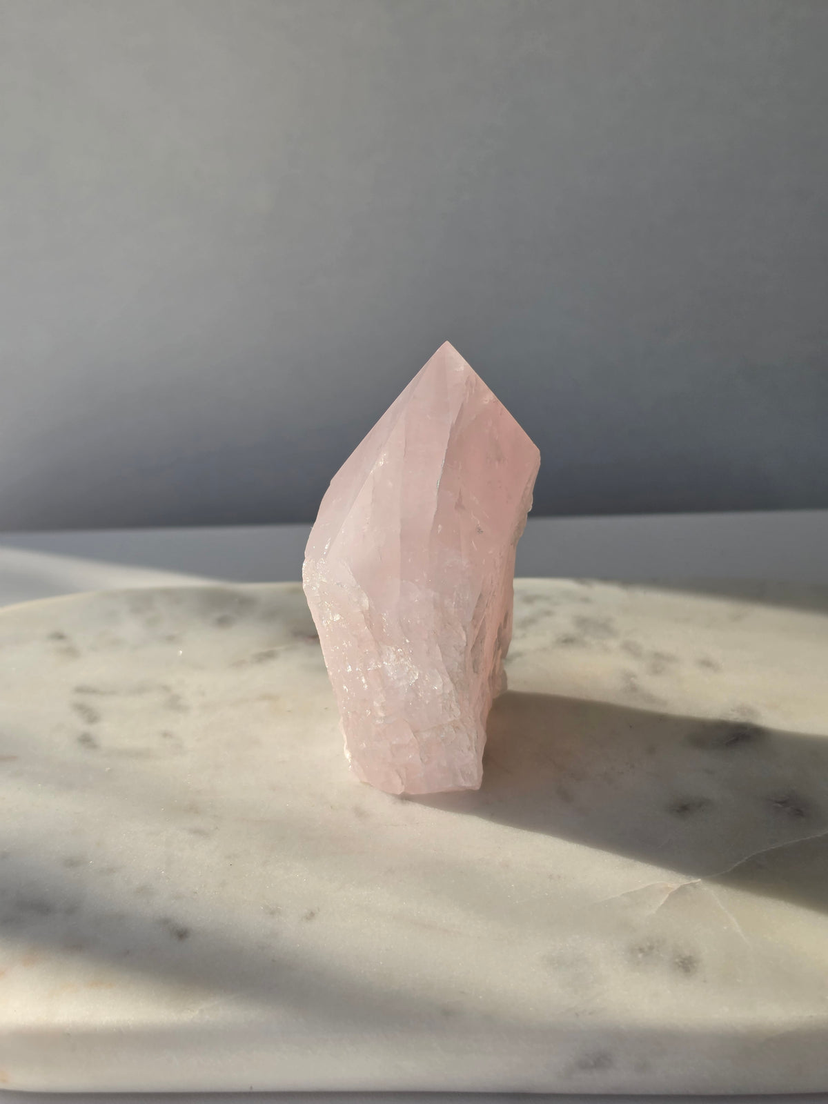 Natural Rose Quartz tower with soft blush-pink colouring, translucent areas and organic crystal formations, weighing 298g and measuring 9.5cm