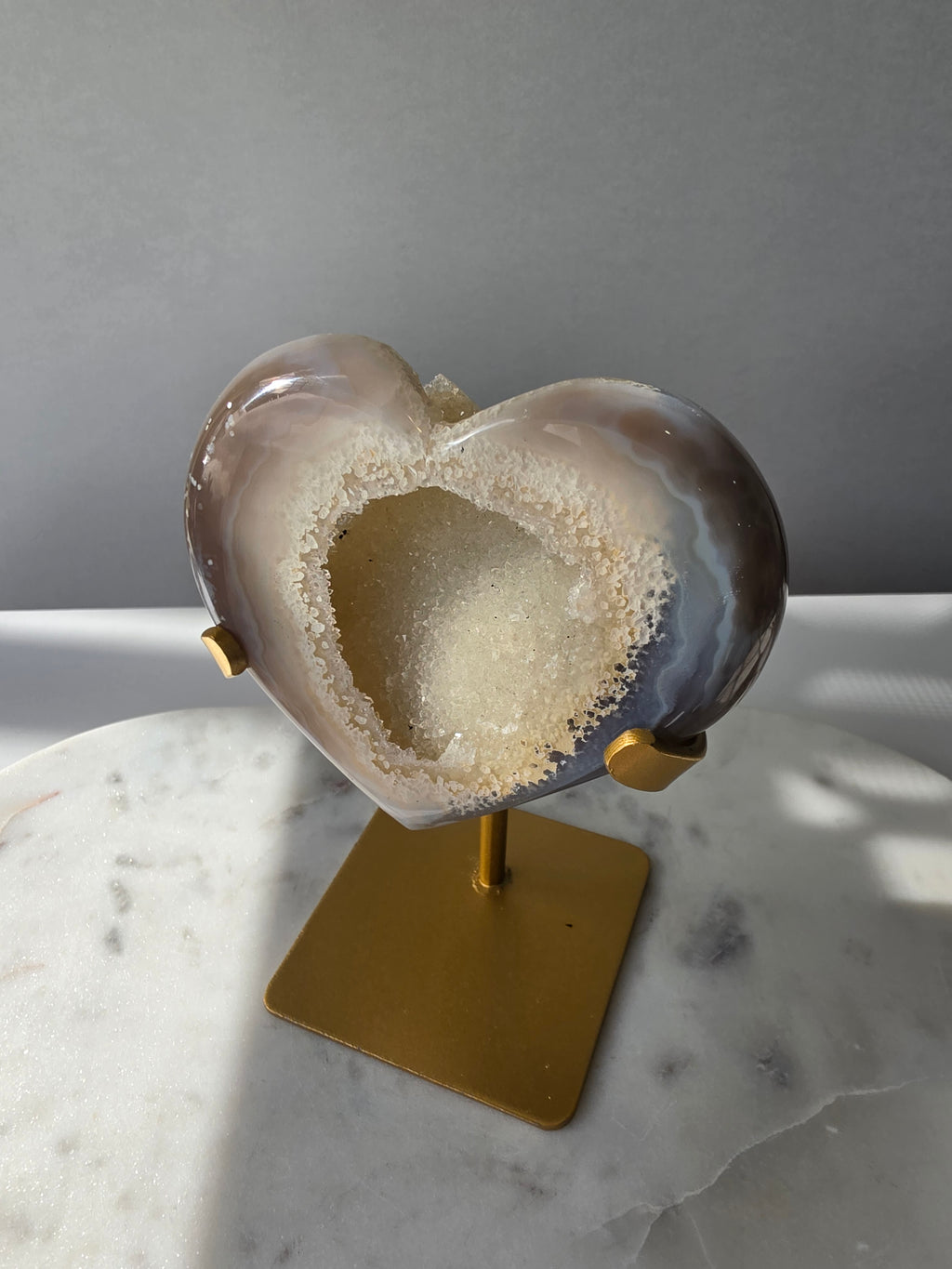 High clarity Druzy Agate Geode Heart on gold stand featuring sparkling druzy crystals, natural agate banding and champagne, taupe and smoky grey tones
