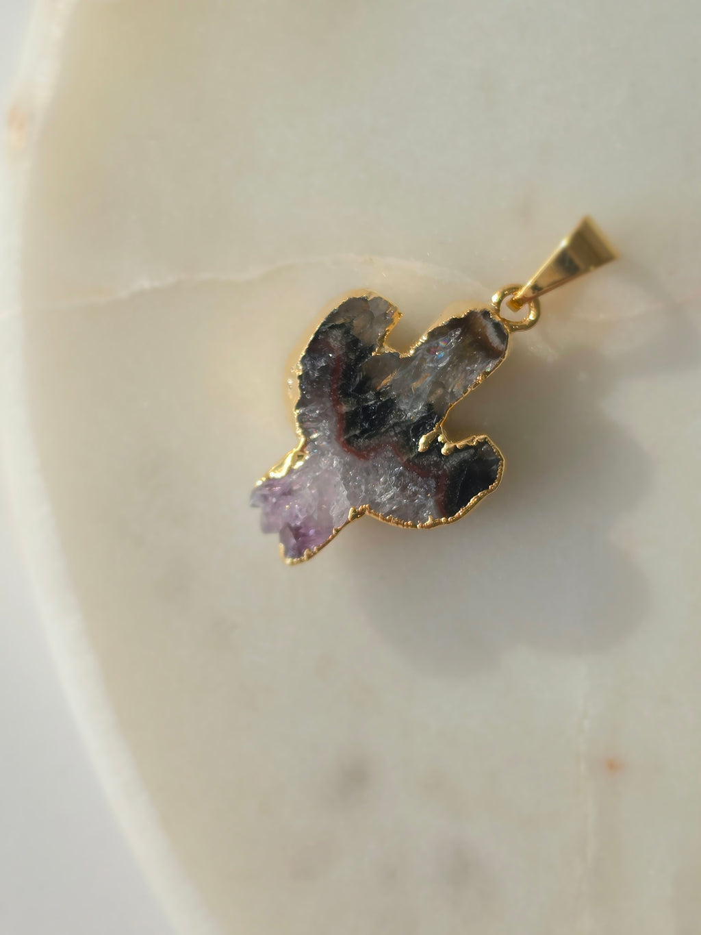 Amethyst and agate cactus slice pendant featuring deep translucent smoky-grey agate, red banding and purple crystal formations and a 24K gold-plated outline.