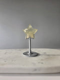 Natural citrine crystal star on a silver stand, featuring translucent golden tones and unique crystal formations, Stone & Bloom statement decor