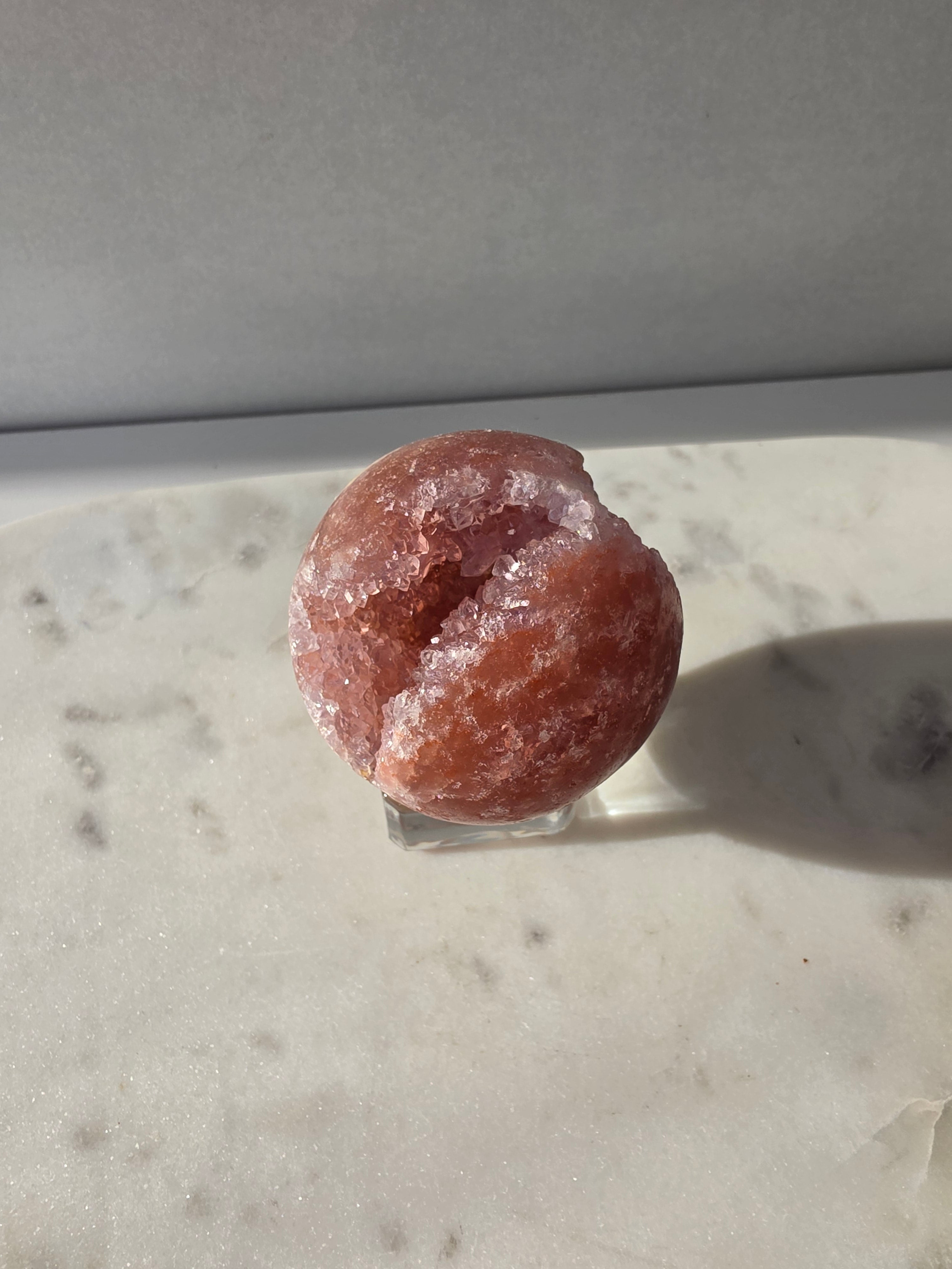 Brazilian Pink Amethyst sphere in rich blush and red-pink tones with sparkling druzy crystal formations and a natural crystalline centre, Stone & Bloom