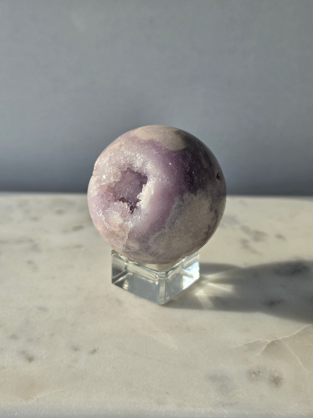 Brazilian Pink Amethyst sphere in soft lilac and lavender tones featuring a sparkling druzy cavity with a natural amethyst flower formation