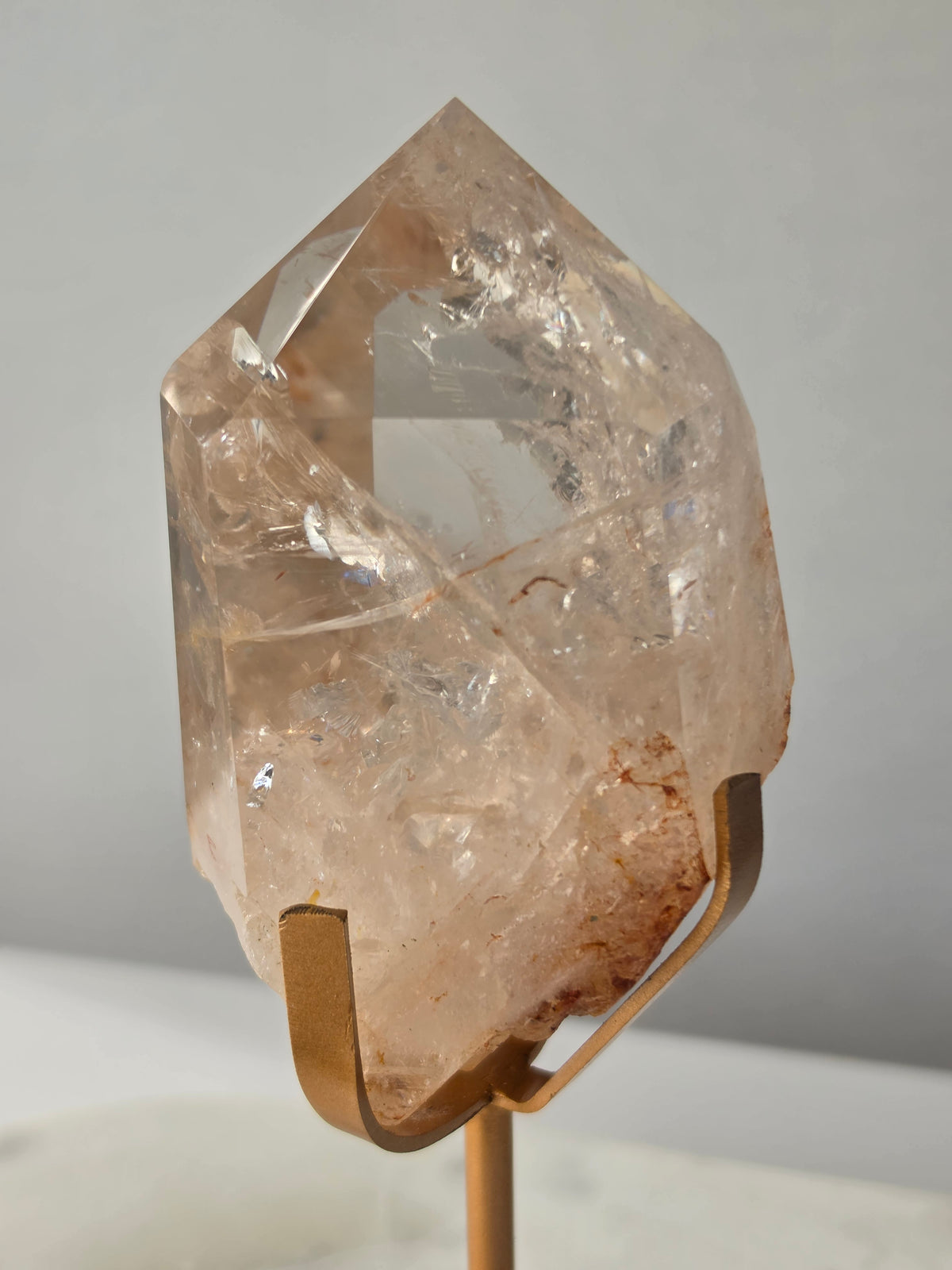 High-grade Nepalese Pink Himalayan Quartz statement piece, 606g and 19cm tall, featuring delicate pink tones, translucent crystal formations and natural inclusions, displayed on a gold stand.