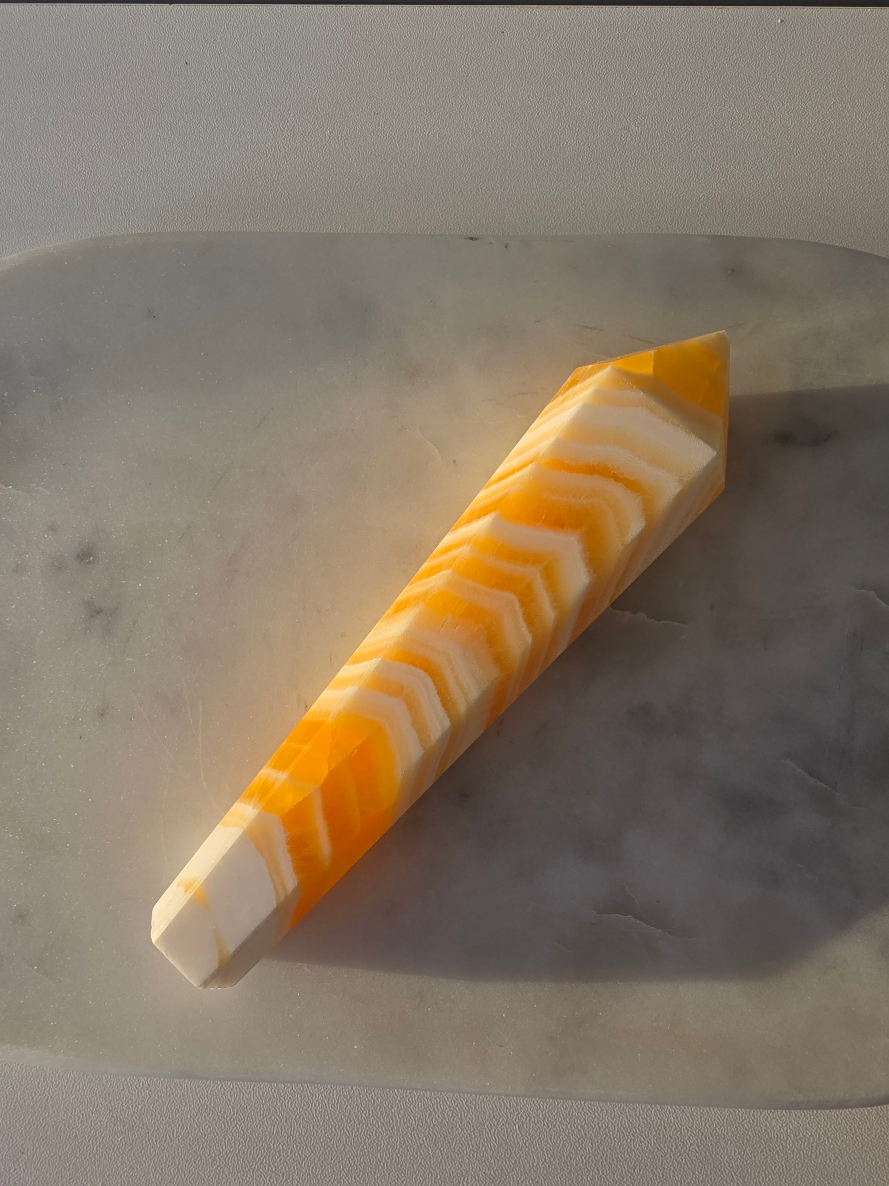Luxury Yellow Banded Calcite Wand by Stone and Bloom featuring warm golden and cream natural banding, on trend, Crystals, Calcite, Wand