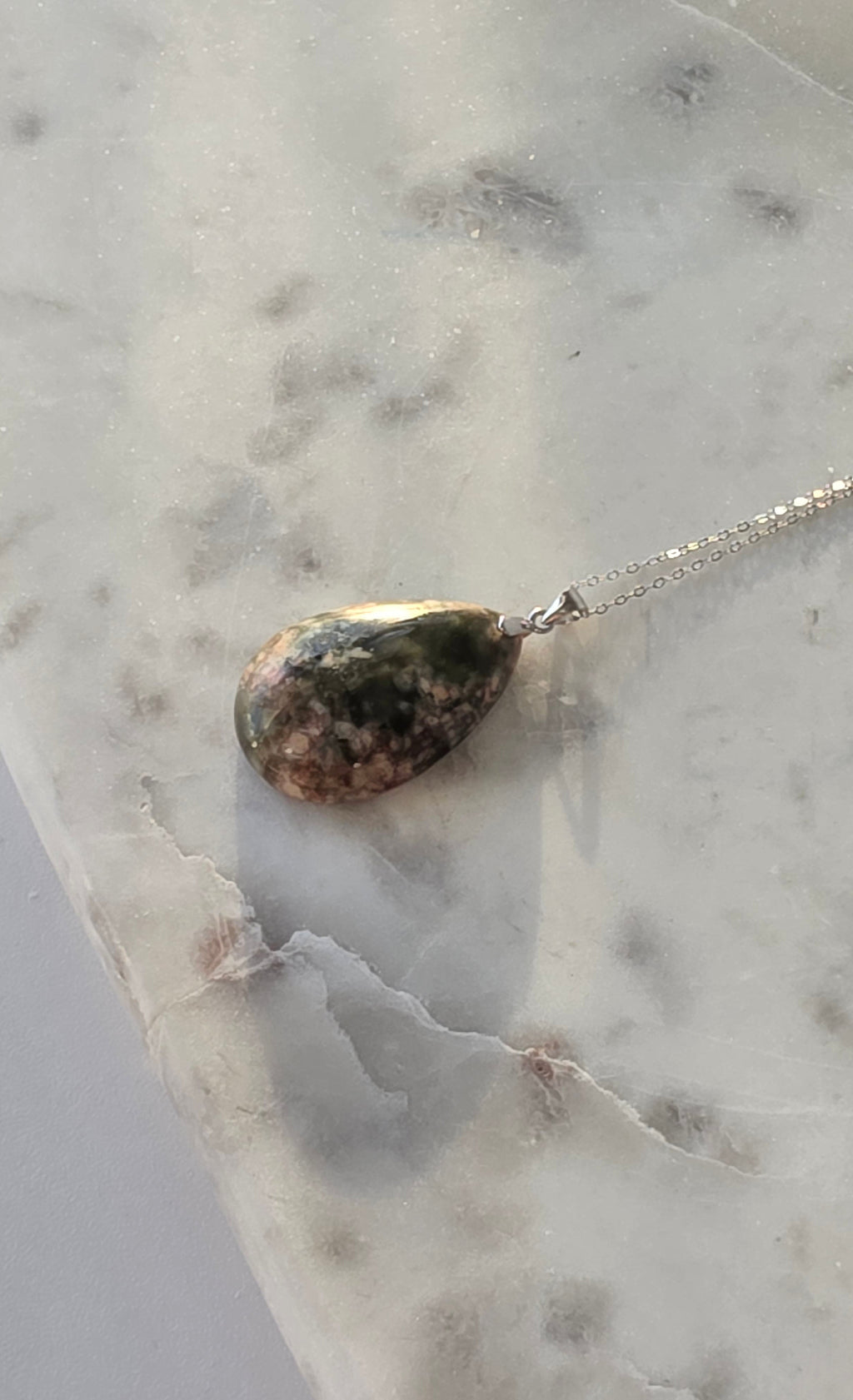 Natural Flower Agate teardrop pendant in 925 sterling silver with matching silver chain, featuring soft pink and white floral patterns