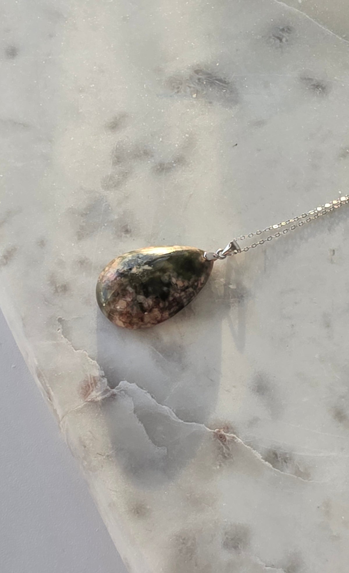 Natural Flower Agate teardrop pendant in 925 sterling silver with matching silver chain, featuring soft pink and white floral patterns