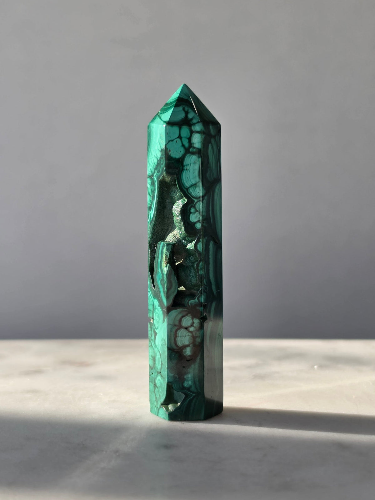 Polished green Malachite Point featuring deep emerald bands, concentric bubble-like formations with sparkles and intricate natural patterns.