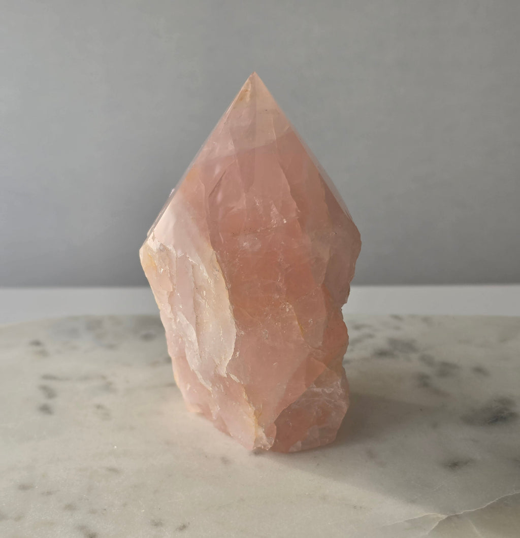 Natural Rose Quartz tower with soft blush-pink colouring and subtle warm golden healer inclusions, weighing 466g and measuring 10cm