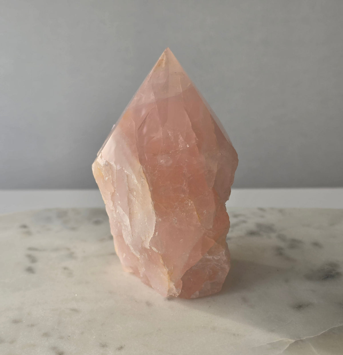 Natural Rose Quartz tower with soft blush-pink colouring and subtle warm golden healer inclusions, weighing 466g and measuring 10cm