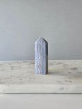 Natural Blue Lace Agate crystal point with soft blue and white banding, polished finish and unique natural formations