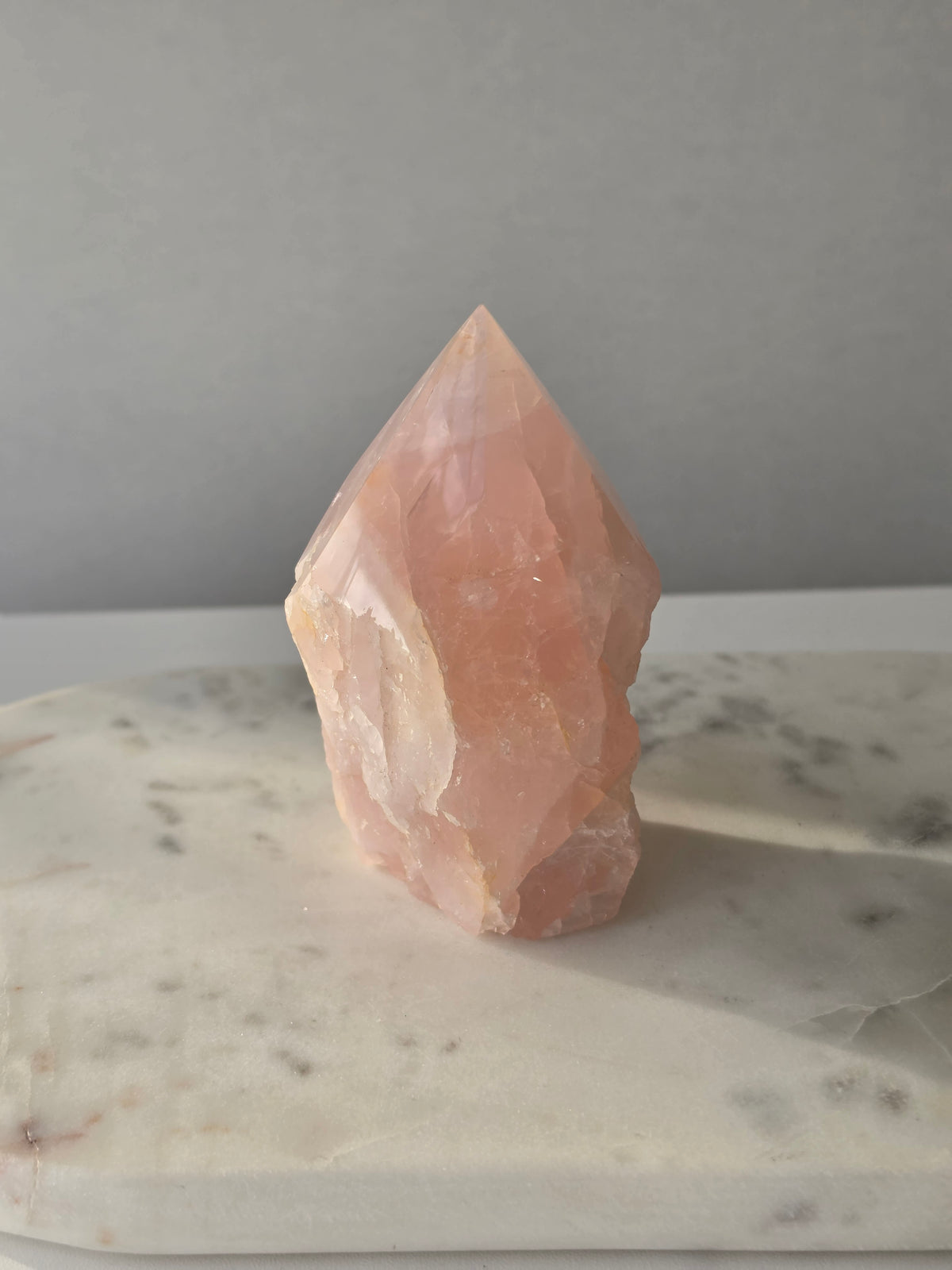 Natural Rose Quartz tower with soft blush-pink colouring and subtle warm golden healer inclusions, weighing 466g and measuring 10cm